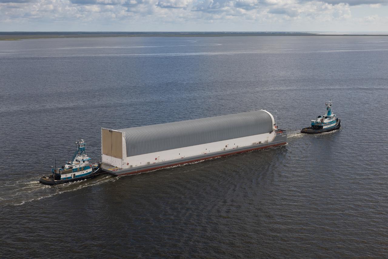 NASA photographers Evan Deroche and Brandon Hancock joined the U.S. Coast Guard in an HH-60 Jayhawk helicopter to capture aerial views of NASA’s Pegasus barge just after it departed NASA’s Michoud Assembly Facility in New Orleans July 17 with the core stage of NASA’s SLS (Space Launch System) rocket for Artemis II. These photos and videos show the barge as it traveled down the Intracoastal Waterway to the Gulf of Mexico. Pegasus ferried the Artemis II core stage more than 900 miles to NASA’s Kennedy Space Center in Florida. It arrived with the flight hardware July 22. The barge is maintained at NASA’s Michoud Assembly Facility in New Orleans, where the core stage is fully manufactured.  NASA is working to land the first woman, first person of color, and its first international partner astronaut on the Moon under Artemis. SLS is part of NASA’s backbone for deep space exploration, along with the Orion spacecraft, supporting ground systems, advanced spacesuits and rovers, the Gateway in orbit around the Moon, and commercial human landing systems. SLS is the only rocket that can send Orion, astronauts, and supplies to the Moon in a single launch.