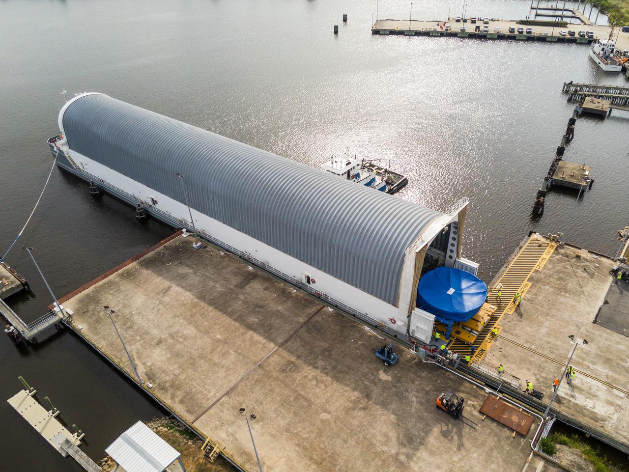 These photos and videos show teams at NASA’s Michoud Assembly Facility in New Orleans preparing, moving, and loading the engine section boat-tail of NASA’s SLS (Space Launch System) rocket for the Artemis III mission for transportation to NASA’s Kennedy Space Center in Florida via the agency’s Pegasus barge. Inside the factory on Aug. 14 prior to the move, technicians covered the spaceflight hardware with a tarp to help protect it on its journey aboard NASA’s Pegasus barge. Crews then rolled out the hardware on Aug. 27 from the factory floor to the barge. Once in Florida, the boat-tail will be integrated with the engine section -- also manufactured at Michoud -- inside Kennedy’s Space Station Processing Facility. The engine section arrived at NASA Kennedy in Dec. 2022. Located at the bottom of the engine section, the aerodynamic boat-tail fairing channels airflow and protects the stage’s four RS-25 engines from extreme temperatures during launch. The engine section is one of five major elements that make up the 212-foot-tall rocket stage. The core stage, along with its four RS-25 engines, produce two million pounds of thrust to help launch NASA’s Orion spacecraft, astronauts, and supplies beyond Earth’s orbit and to the lunar surface for Artemis. 