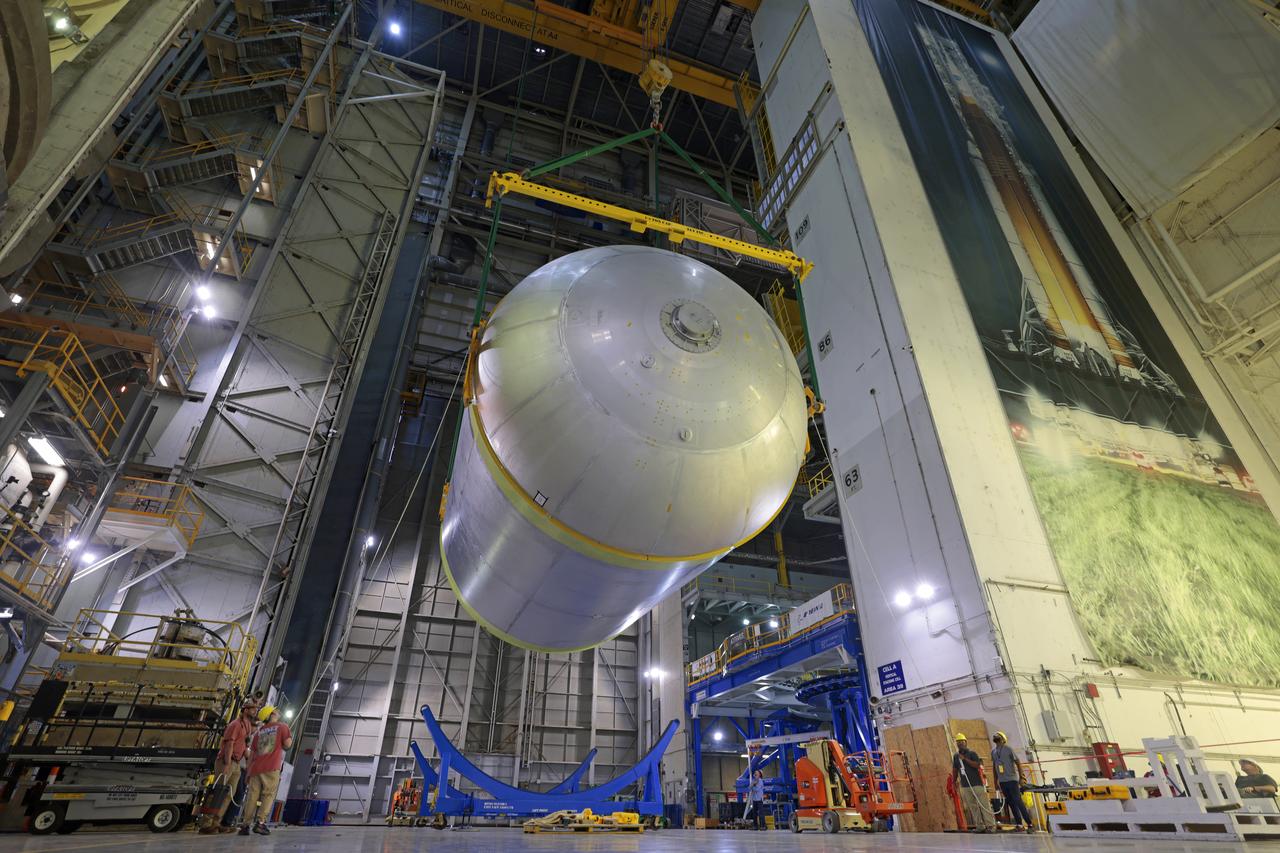 Teams at NASA’s Michoud Assembly Facility in New Orleans move a liquid oxygen tank for its SLS (Space Launch System) rocket to a cleaning cell inside the facility’s vertical assembly building on Oct. 11. The tank, which will be used on the core stage of the agency’s Artemis III mission, will undergo an internal cleaning before moving on to its next phase of production. Inside the cleaning cell, a solution is sprayed into the tank to remove particulates which may collect during the manufacturing process. Once a tank is cleaned, teams use mobile clean rooms for internal access to the tank to prevent external contaminates from entering the hardware. The propellant tank is one of five major elements that make up the 212-foot-tall rocket stage. The core stage, along with its four RS-25 engines, produce more than two million pounds of thrust to help launch NASA’s Orion spacecraft, astronauts, and supplies beyond Earth’s orbit and to the lunar surface for Artemis. Image credit: NASA/Michael DeMocker