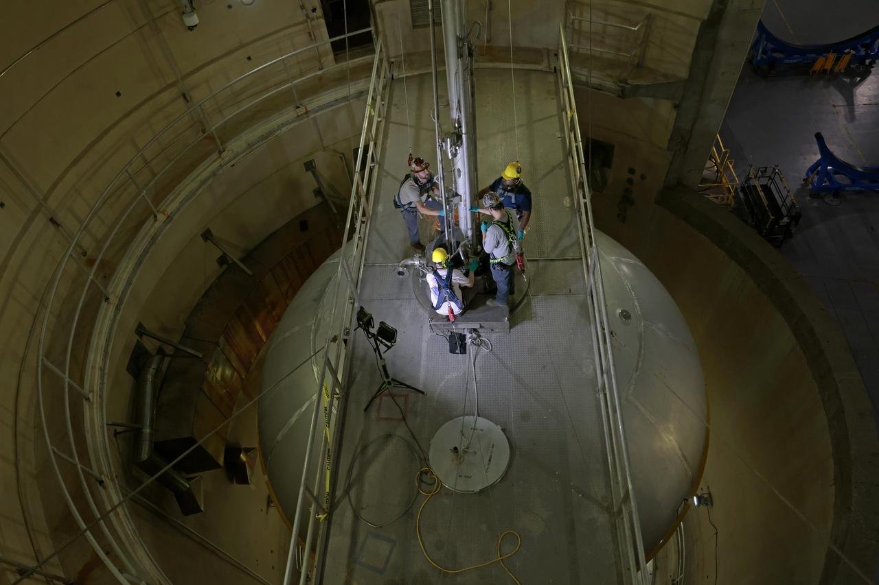 Teams at NASA’s Michoud Assembly Facility in New Orleans install wash probes into a liquid oxygen tank inside the factory’s cleaning cell on Oct. 25. The tank, which will be used on the core stage of the agency’s SLS (Space Launch System) rocket for its Artemis III mission, will undergo an internal cleaning before moving on to its next phase of production. Inside the cleaning cell, a solution is sprayed into the tank to remove particulates which may collect during the manufacturing process. Once a tank is cleaned, teams use mobile clean rooms for internal access to the tank to prevent external contaminates from entering the hardware. The propellant tank is one of five major elements that make up the 212-foot-tall rocket stage. The core stage, along with its four RS-25 engines, produce more than two million pounds of thrust to help launch NASA’s Orion spacecraft, astronauts, and supplies beyond Earth’s orbit and to the lunar surface for Artemis.  Image credit: NASA/Michael DeMocker