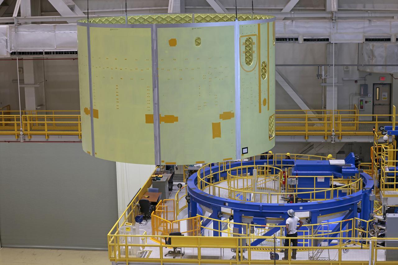 Technicians at NASA’s Michoud Assembly Facility move the engine section of NASA’s Space Launch System rocket for Artemis V on December 18, 2024, at NASA Michoud Assembly Facility in New Orleans, LA. Throughout 2024, new tooling was erected in bldg. 115 for the upcoming iterations of the Space Launch System (SLS), Exploration Upper Stage (EUS), and the test articles required to develop and assemble each efficiently and effectively. This barrel is the sixty-fourth produced for the Space Launch System program since its inception and is the first barrel weld completed for the core stage of the Artemis V mission. This engine section will be used on the evolved Block 1B configuration of the SLS (Space Launch System) rocket. It is one of the first components that will make up a portion of the core stage that will power NASA’s Artemis V mission.  According to a Boeing engineer, as of this barrel, the VWC has now completed 515 production welds, with friction-stir welding a cumulative distance of 111,568 inches. Image credit: NASA/Michael DeMocker