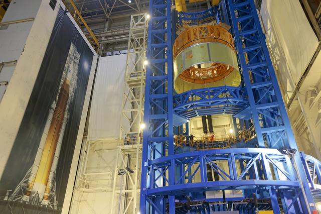 NASA image: Structurally Complete Forward Skirt Lifts Out of Vertical Assembly Center