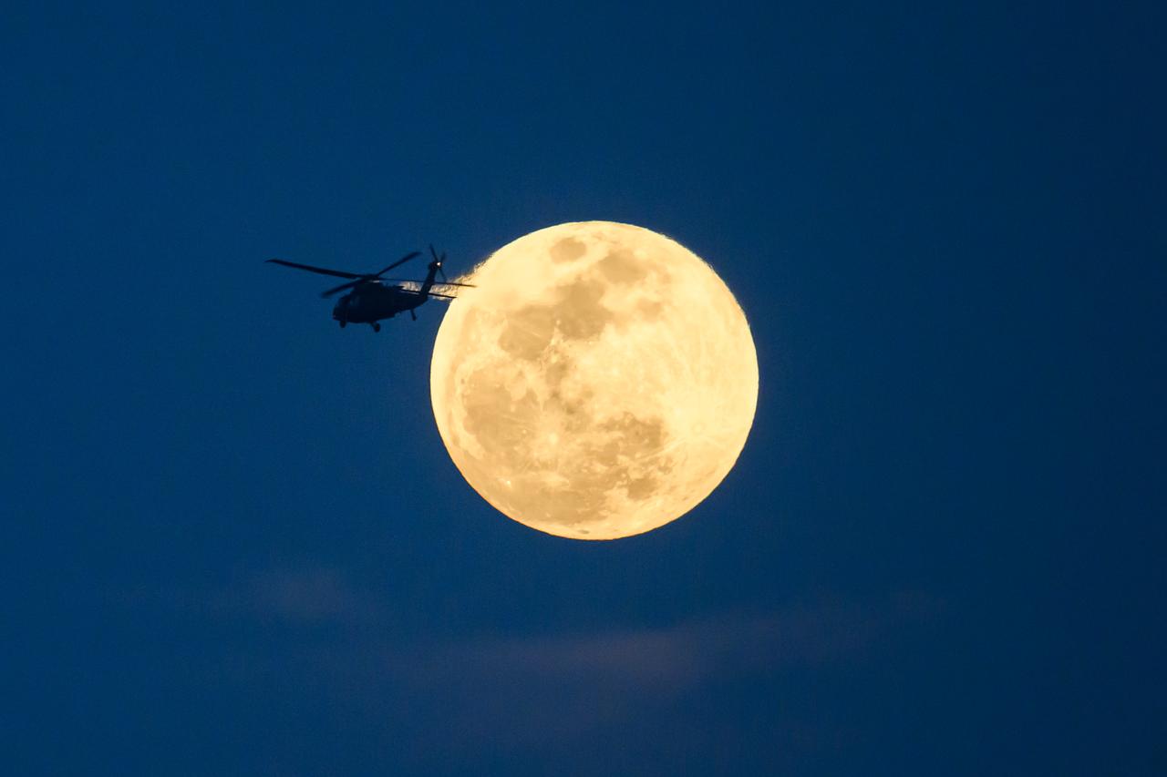 A helicopter passes in front of the moon on the evening of March 13th, near New Orleans, LA.