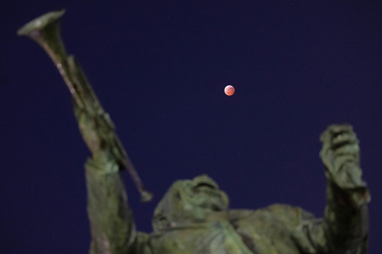 The blood moon lunar eclipse is shown above a statue of Louis Armstrong in New Orleans, home to NASA’s Michoud Assembly Facility, on Friday, March 14, 2025. Image credit: NASA/Michael DeMocker