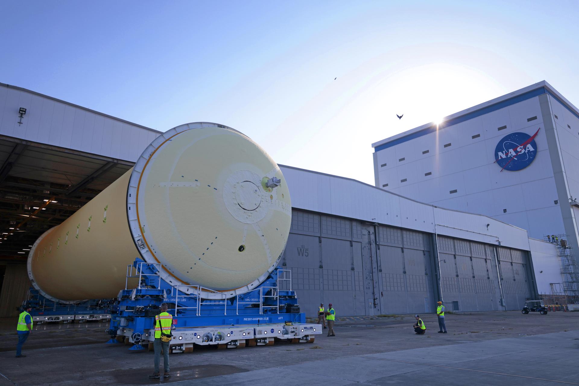 Teams at NASA’s Michoud Assembly Facility in New Orleans move a liquid hydrogen tank for the agency’s SLS (Space Launch System) rocket into the factory’s vertical assembly building on Sep. 26, 2025. The tank, which is designated for the agency’s Artemis III mission, is lifted and loaded into a production cell where it will be mated with the LH2 Transport Adapter Assembly for future transportation to NASA’s Kennedy Space Center. The engine section flight hardware structure was completed in 2022 and was shipped to Kennedy where teams continue to integrate vital systems. The propellant tank is one of five major elements that make up the 212-foot-tall rocket stage. The core stage, along with its four RS-25 engines, produce more than two million pounds of thrust to help launch NASA’s Orion spacecraft, astronauts, and supplies beyond Earth’s orbit and to the lunar surface for Artemis. Image credit: NASA/Michael DeMocker