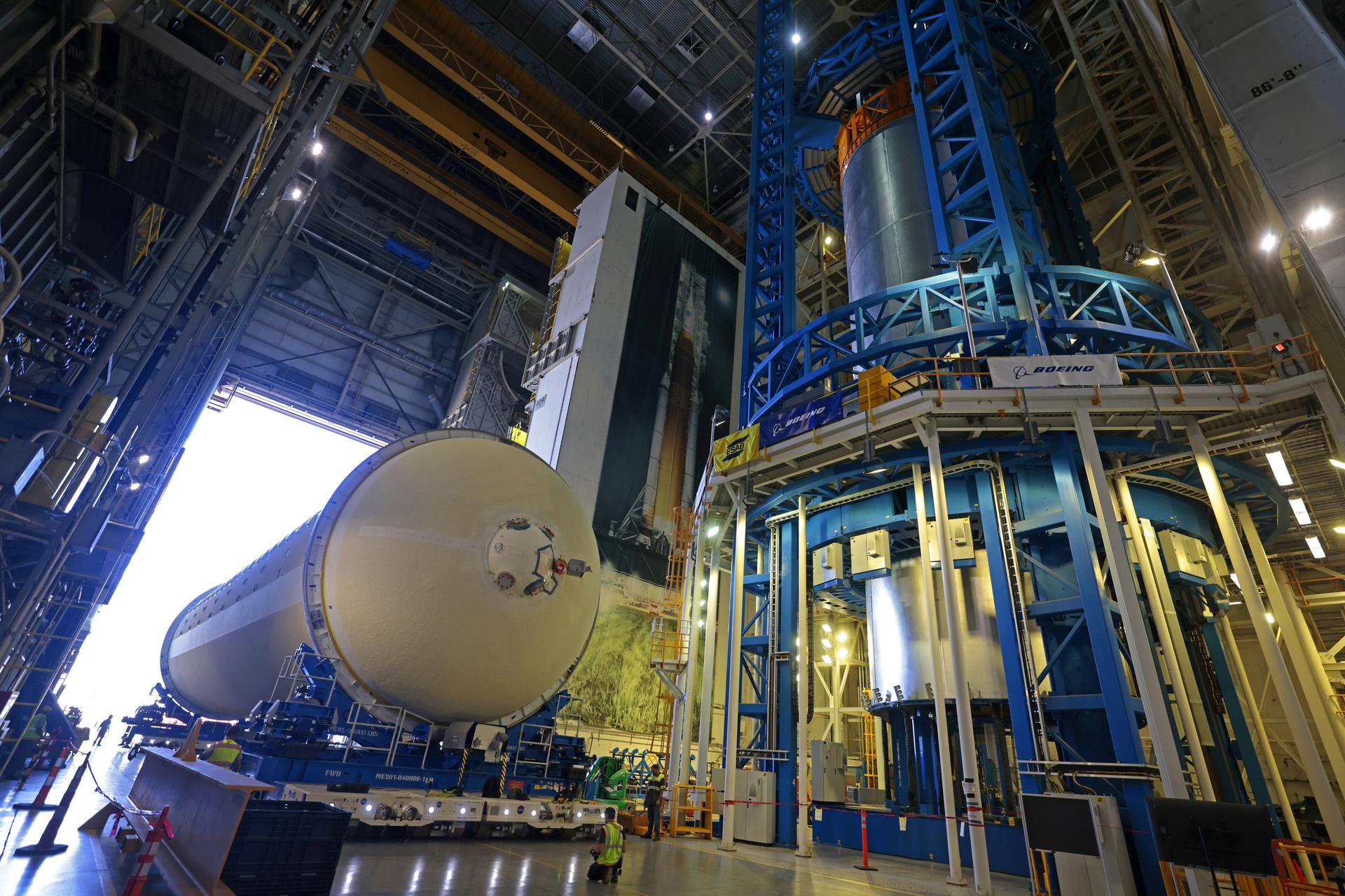 Teams at NASA’s Michoud Assembly Facility in New Orleans move a liquid hydrogen tank for the agency’s SLS (Space Launch System) rocket into the factory’s vertical assembly building on Sep. 26, 2025. The tank, which is designated for the agency’s Artemis III mission, is lifted and loaded into a production cell where it will be mated with the LH2 Transport Adapter Assembly for future transportation to NASA’s Kennedy Space Center. The engine section flight hardware structure was completed in 2022 and was shipped to Kennedy where teams continue to integrate vital systems. The propellant tank is one of five major elements that make up the 212-foot-tall rocket stage. The core stage, along with its four RS-25 engines, produce more than two million pounds of thrust to help launch NASA’s Orion spacecraft, astronauts, and supplies beyond Earth’s orbit and to the lunar surface for Artemis. Image credit: NASA/Michael DeMocker