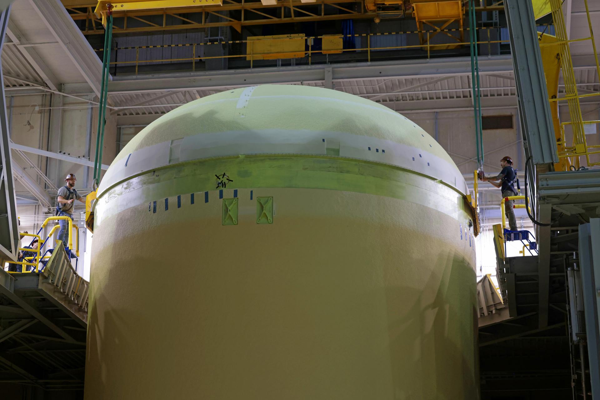 NASA’s Michoud Assembly move crews lift the liquid hydrogen tank for its Artemis III mission out of a production cell on Oct. 6, 2025. Teams with SLS (Space Launch System) prime contractor, Boeing, recently mated the tank to the LH2 Transport Adapter Assembly, which will allow the stage to be securely transported by barge to NASA’s Kennedy Space Center once it’s mated to the forward end of the core stage. The LH2 Transport Adapter Assembly serves as a temporary place holder for the engine section, which was previously shipped from Michoud to NASA’s Kennedy Space Center for further integration. The propellant tank is one of five major elements that make up the 212-foot-tall rocket stage. The core stage, along with its four RS-25 engines, produce more than two million pounds of thrust to help launch NASA’s Orion spacecraft, astronauts, and supplies beyond Earth’s orbit and to the lunar surface for Artemis. Image credit: NASA/Michael DeMocker