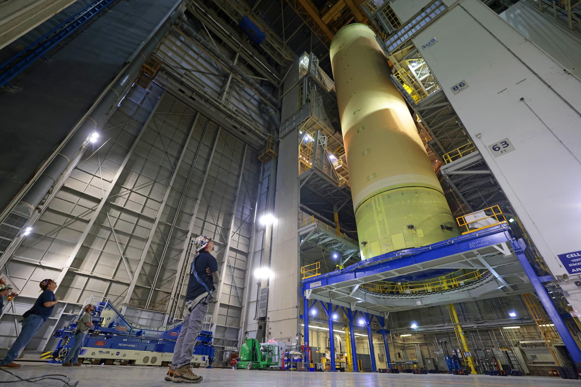 NASA’s Michoud Assembly move crews lift the liquid hydrogen tank for its Artemis III mission out of a production cell on Oct. 6, 2025. Teams with SLS (Space Launch System) prime contractor, Boeing, recently mated the tank to the LH2 Transport Adapter Assembly, which will allow the stage to be securely transported by barge to NASA’s Kennedy Space Center once it’s mated to the forward end of the core stage. The LH2 Transport Adapter Assembly serves as a temporary place holder for the engine section, which was previously shipped from Michoud to NASA’s Kennedy Space Center for further integration. The propellant tank is one of five major elements that make up the 212-foot-tall rocket stage. The core stage, along with its four RS-25 engines, produce more than two million pounds of thrust to help launch NASA’s Orion spacecraft, astronauts, and supplies beyond Earth’s orbit and to the lunar surface for Artemis. Image credit: NASA/Michael DeMocker