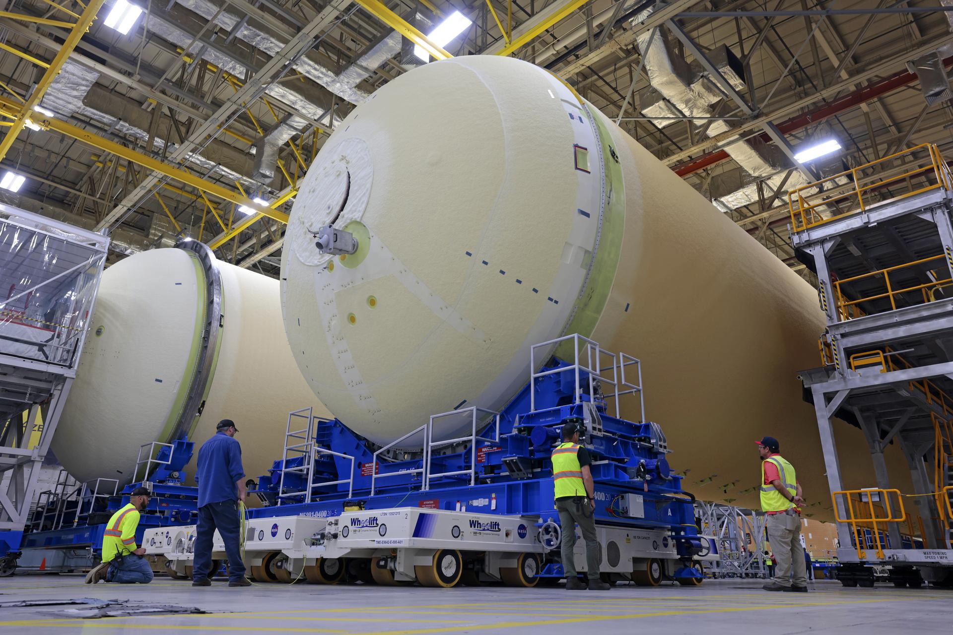 NASA’s Michoud Assembly move crews lift the liquid hydrogen tank for its Artemis III mission out of a production cell and move it into the final assembly manufacturing area on Oct. 10, 2025. Teams with SLS (Space Launch System) prime contractor, Boeing, recently mated the tank to the LH2 Transport Adapter Assembly, which will allow the stage to be securely transported by barge to NASA’s Kennedy Space Center once it’s mated to the forward end of the core stage. The LH2 Transport Adapter Assembly serves as a temporary place holder for the engine section, which was previously shipped from Michoud to NASA’s Kennedy Space Center for further integration.  The propellant tank is one of five major elements that make up the 212-foot-tall rocket stage. The core stage, along with its four RS-25 engines, produce more than two million pounds of thrust to help launch NASA’s Orion spacecraft, astronauts, and supplies beyond Earth’s orbit and to the lunar surface for Artemis.    Image credit: NASA/Michael DeMocker