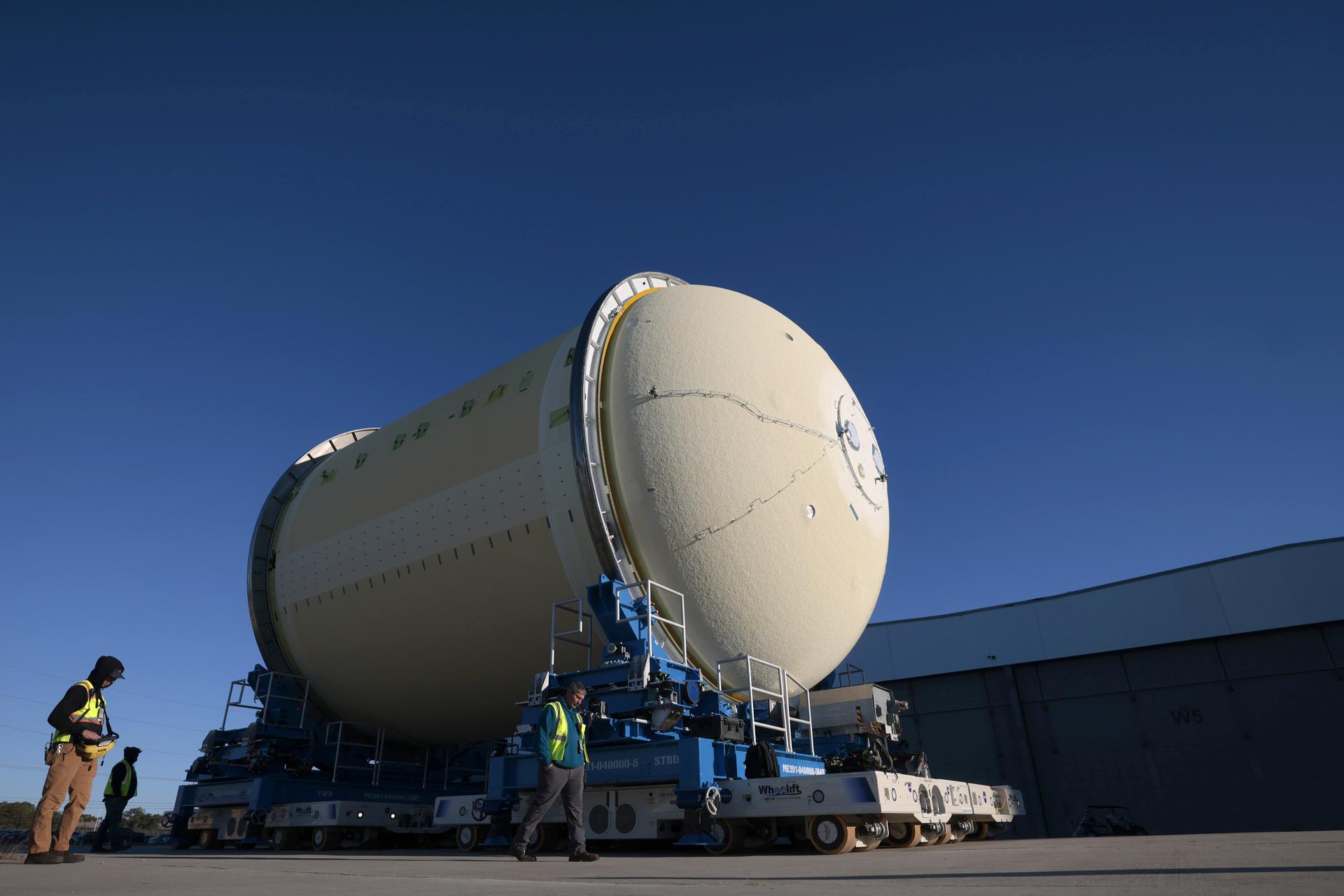 Move crews at NASA’s Michoud Assembly Facility in New Orleans move the liquid oxygen tank for the core stage of the agency’s Artemis III mission into the facility’s vertical assembly building on Nov.3. Eventually, teams with SLS (Space Launch System) prime contractor, Boeing, will lift the tank into the production cell currently housing the intertank and mate the flight hardware together before capping them off with the forward skirt to complete the core stage forward join.   The propellant tank is one of five major elements that make up the 212-foot-tall rocket stage. The core stage, along with its four RS-25 engines, produce more than two million pounds of thrust to help launch NASA’s Orion spacecraft, astronauts, and supplies beyond Earth’s orbit and to the lunar surface for Artemis.   Image credit: NASA/Michael DeMocker