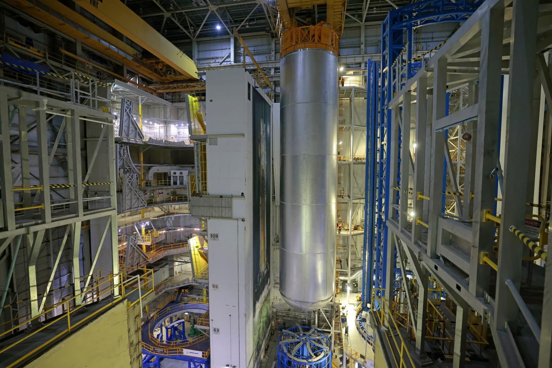 Teams at NASA’s Michoud Assembly Facility in New Orleans lift the 130-foot-tall liquid hydrogen tank off the vertical assembly center on Nov. 14. This is the fourth liquid hydrogen tank manufactured at the facility for the agency’s SLS (Space Launch System) rocket. The completed tank will be loaded into a production cell for technicians to remove the lift tool, perform dimensional scans, and then install brackets, which will allow the move crew to break the tank over from a vertical to a horizontal configuration.  The propellant tank is one of five major elements that make up the 212-foot-tall rocket stage. The core stage, along with its four RS-25 engines, produce more than two million pounds of thrust to help launch NASA’s Orion spacecraft, astronauts, and supplies beyond Earth’s orbit and to the lunar surface for Artemis.    Image credit: NASA/Michael DeMocker