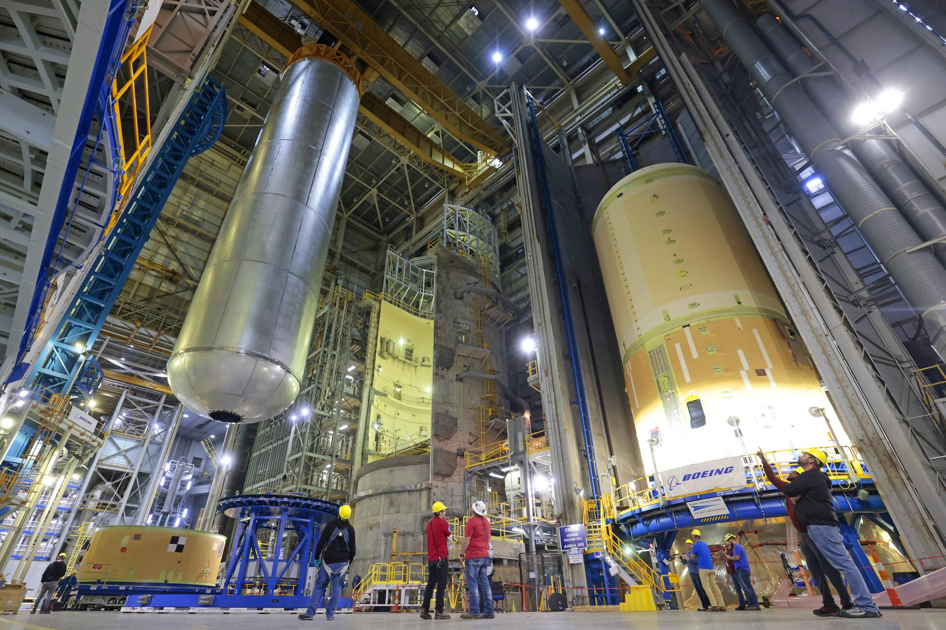 Teams at NASA’s Michoud Assembly Facility in New Orleans lift the 130-foot-tall liquid hydrogen tank off the vertical assembly center on Nov. 14. This is the fourth liquid hydrogen tank manufactured at the facility for the agency’s SLS (Space Launch System) rocket. The completed tank will be loaded into a production cell for technicians to remove the lift tool, perform dimensional scans, and then install brackets, which will allow the move crew to break the tank over from a vertical to a horizontal configuration.  The propellant tank is one of five major elements that make up the 212-foot-tall rocket stage. The core stage, along with its four RS-25 engines, produce more than two million pounds of thrust to help launch NASA’s Orion spacecraft, astronauts, and supplies beyond Earth’s orbit and to the lunar surface for Artemis.    Image credit: NASA/Michael DeMocker
