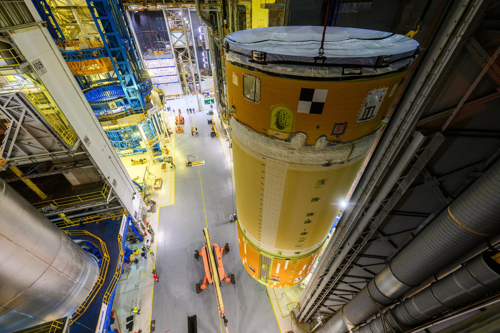 Move crews at NASA’s Michoud Assembly Facility in New Orleans, lift the forward-joined flight hardware for the agency’s SLS (Space Launch System) rocket out of a stacking cell in the vertical assembly building on Dec. 19, 2025. The forward join, which consists of the intertank, liquid oxygen tank, and forward skirt, will be used on the core stage slated for NASA’s Artemis III mission. Teams moved the flight hardware from the cell and set it atop self-propelled mobile transporters. Soon, the article will be brought to the factory’s final assembly area where it will be mated to the core stage’s previously joined liquid hydrogen tank and undergo further integration.  The core stage, along with its four RS-25 engines, produce more than two million pounds of thrust to help launch NASA’s Orion spacecraft, astronauts, and supplies beyond Earth’s orbit and to the lunar surface for Artemis.