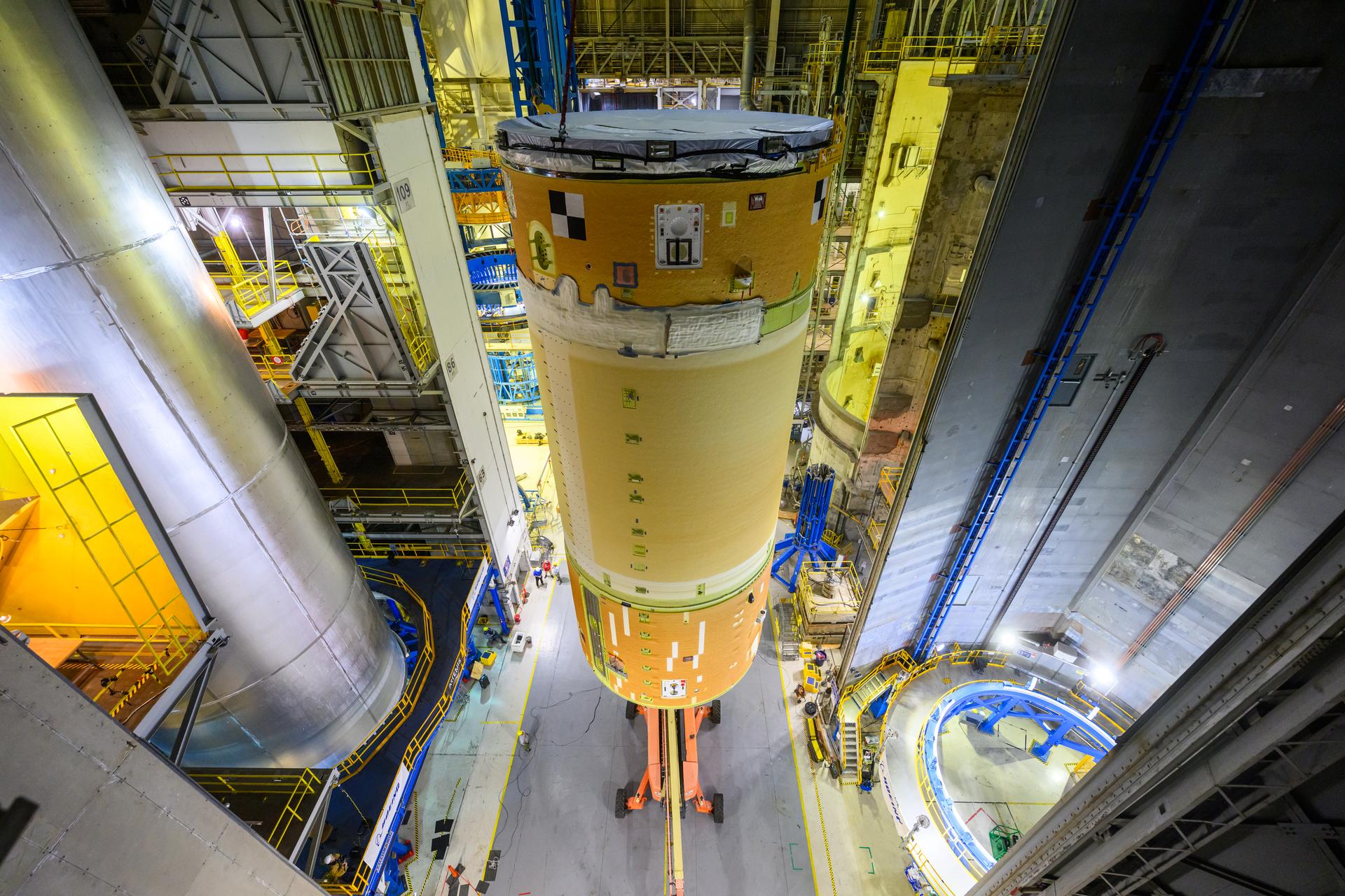 Move crews at NASA’s Michoud Assembly Facility in New Orleans, lift the forward-joined flight hardware for the agency’s SLS (Space Launch System) rocket out of a stacking cell in the vertical assembly building on Dec. 19, 2025. The forward join, which consists of the intertank, liquid oxygen tank, and forward skirt, will be used on the core stage slated for NASA’s Artemis III mission. Teams moved the flight hardware from the cell and set it atop self-propelled mobile transporters. Soon, the article will be brought to the factory’s final assembly area where it will be mated to the core stage’s previously joined liquid hydrogen tank and undergo further integration.  The core stage, along with its four RS-25 engines, produce more than two million pounds of thrust to help launch NASA’s Orion spacecraft, astronauts, and supplies beyond Earth’s orbit and to the lunar surface for Artemis.