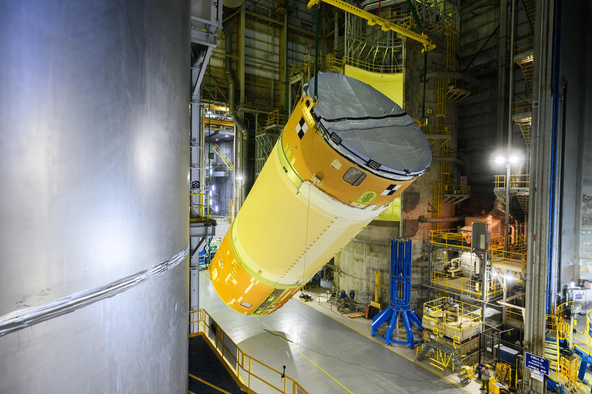 Move crews at NASA’s Michoud Assembly Facility in New Orleans, lift the forward-joined flight hardware for the agency’s SLS (Space Launch System) rocket out of a stacking cell in the vertical assembly building on Dec. 19, 2025. The forward join, which consists of the intertank, liquid oxygen tank, and forward skirt, will be used on the core stage slated for NASA’s Artemis III mission. Teams moved the flight hardware from the cell and set it atop self-propelled mobile transporters. Soon, the article will be brought to the factory’s final assembly area where it will be mated to the core stage’s previously joined liquid hydrogen tank and undergo further integration.  The core stage, along with its four RS-25 engines, produce more than two million pounds of thrust to help launch NASA’s Orion spacecraft, astronauts, and supplies beyond Earth’s orbit and to the lunar surface for Artemis.