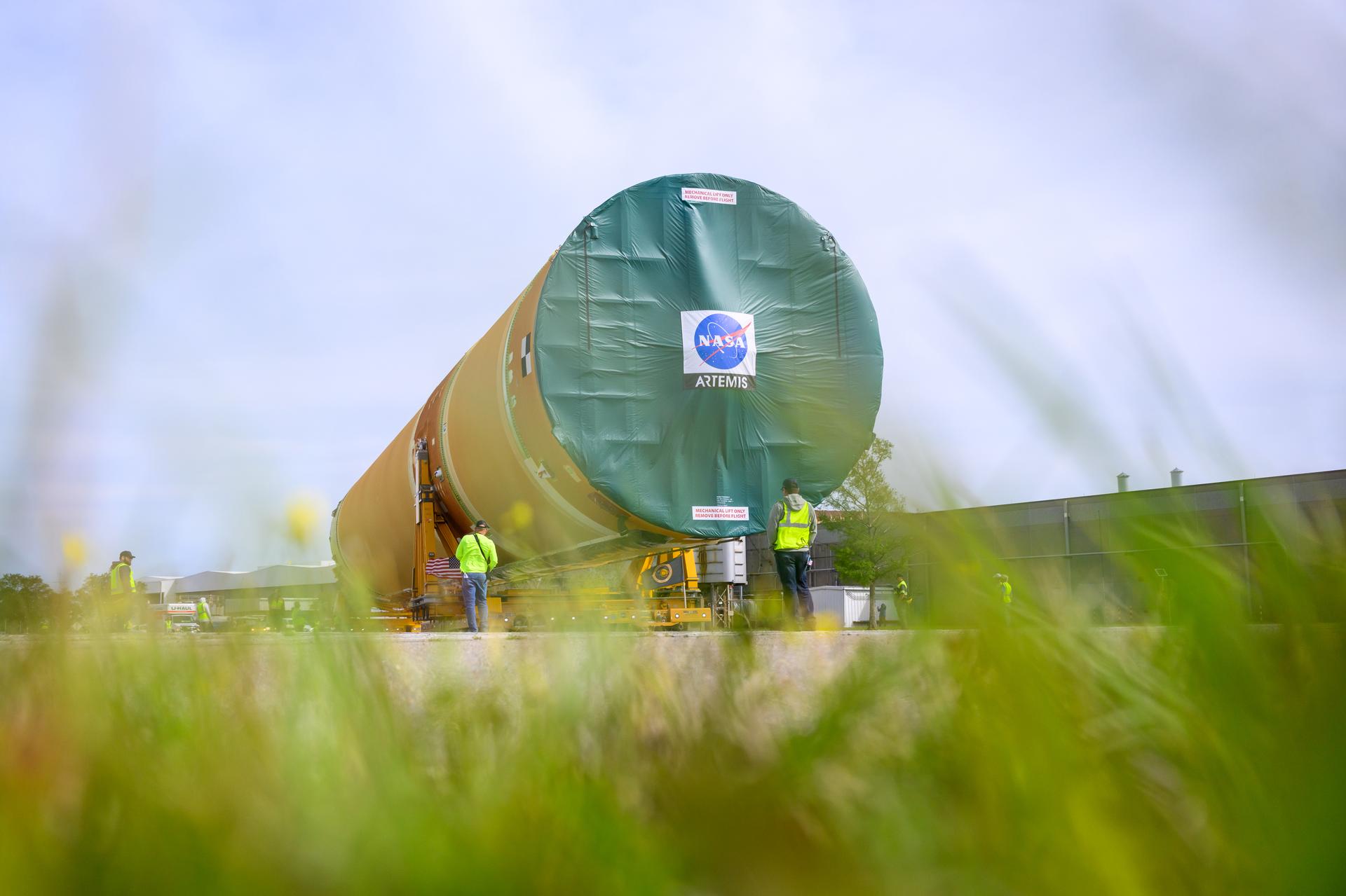 NASA moved the core stage, or the largest section, of the SLS (Space Launch System) rocket that will launch the crewed Artemis III mission in 2027 from the agency’s Michoud Assembly Facility to the agency’s Pegasus barge in New Orleans on April 20. The barge will ferry the top four-fifths – the section containing the liquid hydrogen tank, liquid oxygen tank, intertank, and forward skirt – of the SLS core stage to NASA’s Kennedy Space Center in Florida to complete outfitting and vertical integration.  Teams with NASA and Boeing, the SLS core stage lead contractor, used specialized transporters to guide the top four-fifths from the NASA rocket factory to Pegasus. Prior to the move, technicians added an engine section transportation simulator to the rocket stage for shipment to the Space Coast.  Next year’s Artemis III mission will launch astronauts to Earth’s orbit aboard the Orion spacecraft on top of SLS to test rendezvous and docking capabilities between Orion and commercial spacecraft needed to land Artemis IV astronauts on the Moon in 2028. NASA’s SLS is the only rocket capable of sending Orion, astronauts, and supplies to the Moon in a single launch.  Photo Credit: NASA/Eric Bordelon