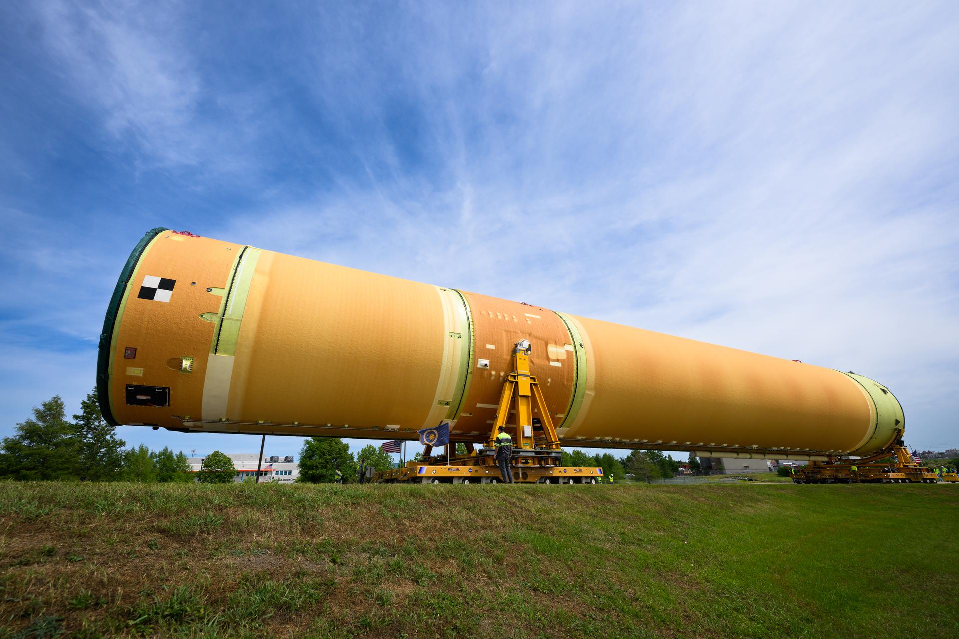NASA moved the core stage, or the largest section, of the SLS (Space Launch System) rocket that will launch the crewed Artemis III mission in 2027 from the agency’s Michoud Assembly Facility to the agency’s Pegasus barge in New Orleans on April 20. The barge will ferry the top four-fifths – the section containing the liquid hydrogen tank, liquid oxygen tank, intertank, and forward skirt – of the SLS core stage to NASA’s Kennedy Space Center in Florida to complete outfitting and vertical integration.  Teams with NASA and Boeing, the SLS core stage lead contractor, used specialized transporters to guide the top four-fifths from the NASA rocket factory to Pegasus. Prior to the move, technicians added an engine section transportation simulator to the rocket stage for shipment to the Space Coast.  Next year’s Artemis III mission will launch astronauts to Earth’s orbit aboard the Orion spacecraft on top of SLS to test rendezvous and docking capabilities between Orion and commercial spacecraft needed to land Artemis IV astronauts on the Moon in 2028. NASA’s SLS is the only rocket capable of sending Orion, astronauts, and supplies to the Moon in a single launch.  Photo Credit: NASA/Eric Bordelon