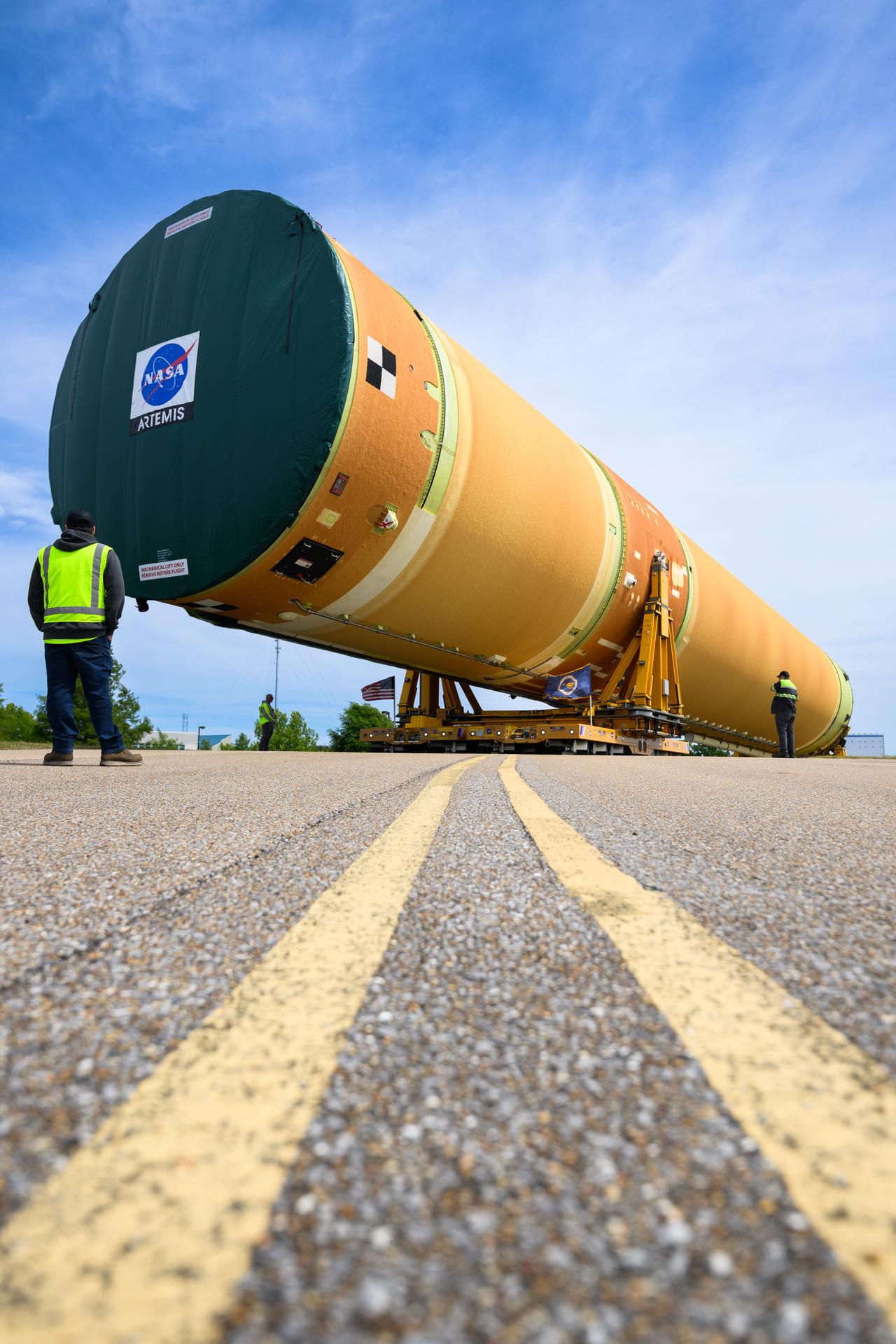 NASA moved the core stage, or the largest section, of the SLS (Space Launch System) rocket that will launch the crewed Artemis III mission in 2027 from the agency’s Michoud Assembly Facility to the agency’s Pegasus barge in New Orleans on April 20. The barge will ferry the top four-fifths – the section containing the liquid hydrogen tank, liquid oxygen tank, intertank, and forward skirt – of the SLS core stage to NASA’s Kennedy Space Center in Florida to complete outfitting and vertical integration.  Teams with NASA and Boeing, the SLS core stage lead contractor, used specialized transporters to guide the top four-fifths from the NASA rocket factory to Pegasus. Prior to the move, technicians added an engine section transportation simulator to the rocket stage for shipment to the Space Coast.  Next year’s Artemis III mission will launch astronauts to Earth’s orbit aboard the Orion spacecraft on top of SLS to test rendezvous and docking capabilities between Orion and commercial spacecraft needed to land Artemis IV astronauts on the Moon in 2028. NASA’s SLS is the only rocket capable of sending Orion, astronauts, and supplies to the Moon in a single launch.  Photo Credit: NASA/Eric Bordelon