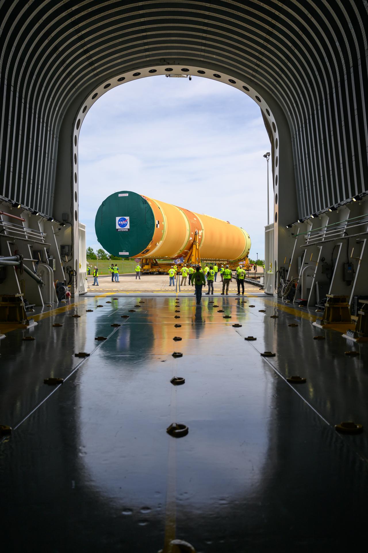 NASA moved the core stage, or the largest section, of the SLS (Space Launch System) rocket that will launch the crewed Artemis III mission in 2027 from the agency’s Michoud Assembly Facility to the agency’s Pegasus barge in New Orleans on April 20. The barge will ferry the top four-fifths – the section containing the liquid hydrogen tank, liquid oxygen tank, intertank, and forward skirt – of the SLS core stage to NASA’s Kennedy Space Center in Florida to complete outfitting and vertical integration.  Teams with NASA and Boeing, the SLS core stage lead contractor, used specialized transporters to guide the top four-fifths from the NASA rocket factory to Pegasus. Prior to the move, technicians added an engine section transportation simulator to the rocket stage for shipment to the Space Coast.  Next year’s Artemis III mission will launch astronauts to Earth’s orbit aboard the Orion spacecraft on top of SLS to test rendezvous and docking capabilities between Orion and commercial spacecraft needed to land Artemis IV astronauts on the Moon in 2028. NASA’s SLS is the only rocket capable of sending Orion, astronauts, and supplies to the Moon in a single launch. 