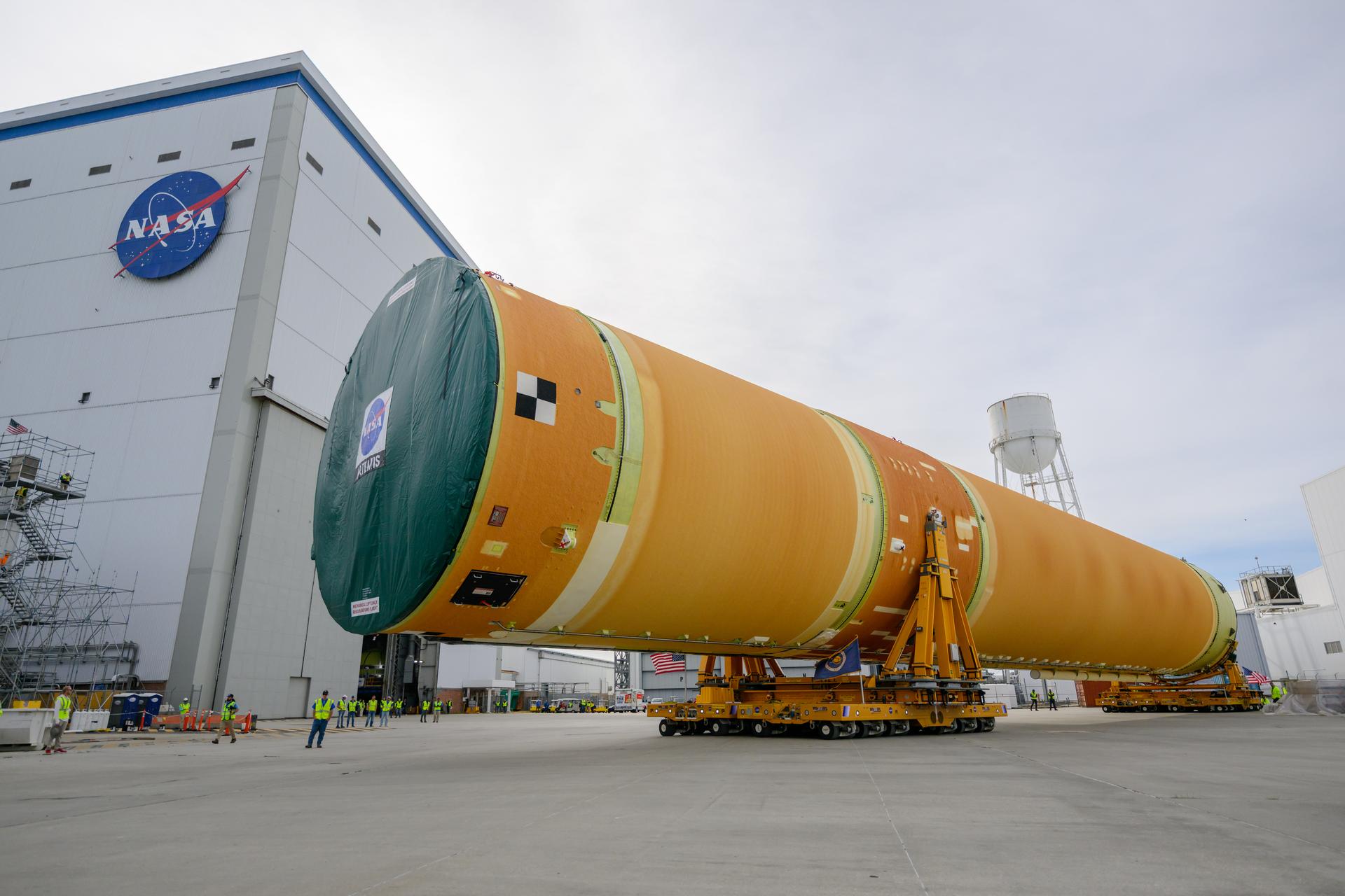 NASA moved the core stage, or the largest section, of the SLS (Space Launch System) rocket that will launch the crewed Artemis III mission in 2027 from the agency’s Michoud Assembly Facility to the agency’s Pegasus barge in New Orleans on April 20. The barge will ferry the top four-fifths – the section containing the liquid hydrogen tank, liquid oxygen tank, intertank, and forward skirt – of the SLS core stage to NASA’s Kennedy Space Center in Florida to complete outfitting and vertical integration.  Teams with NASA and Boeing, the SLS core stage lead contractor, used specialized transporters to guide the top four-fifths from the NASA rocket factory to Pegasus. Prior to the move, technicians added an engine section transportation simulator to the rocket stage for shipment to the Space Coast.  Next year’s Artemis III mission will launch astronauts to Earth’s orbit aboard the Orion spacecraft on top of SLS to test rendezvous and docking capabilities between Orion and commercial spacecraft needed to land Artemis IV astronauts on the Moon in 2028. NASA’s SLS is the only rocket capable of sending Orion, astronauts, and supplies to the Moon in a single launch.  Photo Credit: NASA/Eric Bordelon