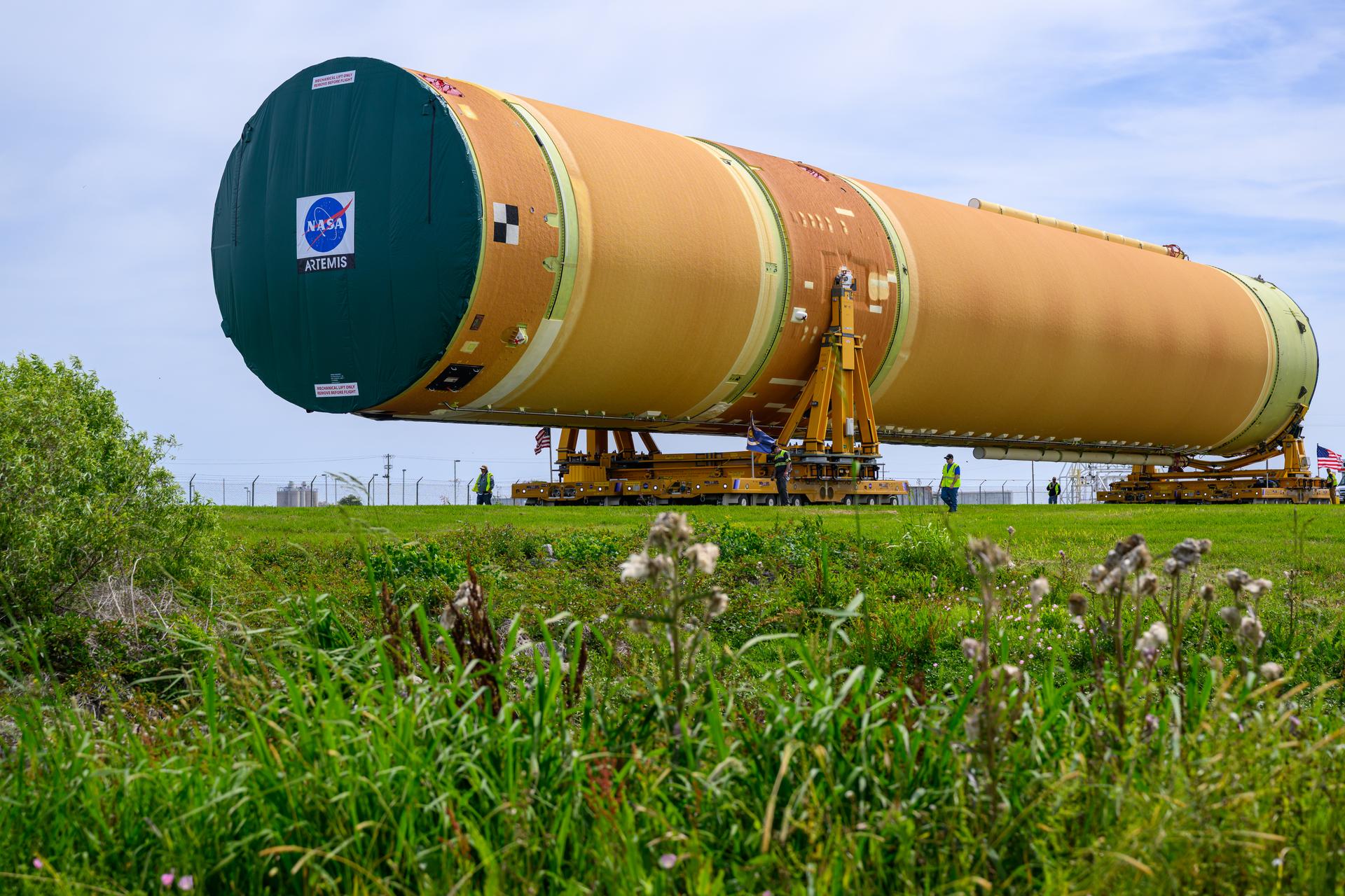 NASA moved the core stage, or the largest section, of the SLS (Space Launch System) rocket that will launch the crewed Artemis III mission in 2027 from the agency’s Michoud Assembly Facility to the agency’s Pegasus barge in New Orleans on April 20. The barge will ferry the top four-fifths – the section containing the liquid hydrogen tank, liquid oxygen tank, intertank, and forward skirt – of the SLS core stage to NASA’s Kennedy Space Center in Florida to complete outfitting and vertical integration.  Teams with NASA and Boeing, the SLS core stage lead contractor, used specialized transporters to guide the top four-fifths from the NASA rocket factory to Pegasus. Prior to the move, technicians added an engine section transportation simulator to the rocket stage for shipment to the Space Coast.  Next year’s Artemis III mission will launch astronauts to Earth’s orbit aboard the Orion spacecraft on top of SLS to test rendezvous and docking capabilities between Orion and commercial spacecraft needed to land Artemis IV astronauts on the Moon in 2028. NASA’s SLS is the only rocket capable of sending Orion, astronauts, and supplies to the Moon in a single launch.  Photo Credit: NASA/Eric Bordelon