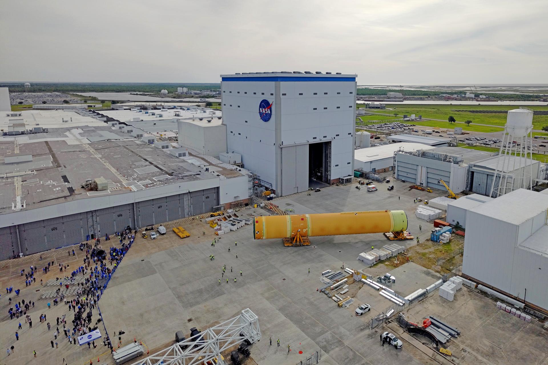 NASA moved the core stage, or the largest section, of the SLS (Space Launch System) rocket that will launch the crewed Artemis III mission in 2027 from the agency’s Michoud Assembly Facility to the agency’s Pegasus barge in New Orleans on April 20. The barge will ferry the top four-fifths – the section containing the liquid hydrogen tank, liquid oxygen tank, intertank, and forward skirt – of the SLS core stage to NASA’s Kennedy Space Center in Florida to complete outfitting and vertical integration.  Teams with NASA and Boeing, the SLS core stage lead contractor, used specialized transporters to guide the top four-fifths from the NASA rocket factory to Pegasus. Prior to the move, technicians added an engine section transportation simulator to the rocket stage for shipment to the Space Coast.  Next year’s Artemis III mission will launch astronauts to Earth’s orbit aboard the Orion spacecraft on top of SLS to test rendezvous and docking capabilities between Orion and commercial spacecraft needed to land Artemis IV astronauts on the Moon in 2028. NASA’s SLS is the only rocket capable of sending Orion, astronauts, and supplies to the Moon in a single launch.  Image credit: NASA/Michael DeMocker