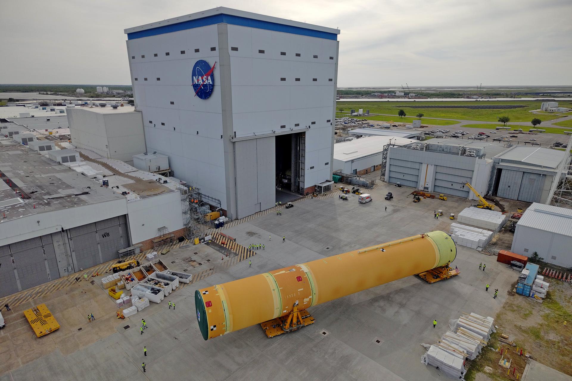 NASA moved the core stage, or the largest section, of the SLS (Space Launch System) rocket that will launch the crewed Artemis III mission in 2027 from the agency’s Michoud Assembly Facility to the agency’s Pegasus barge in New Orleans on April 20. The barge will ferry the top four-fifths – the section containing the liquid hydrogen tank, liquid oxygen tank, intertank, and forward skirt – of the SLS core stage to NASA’s Kennedy Space Center in Florida to complete outfitting and vertical integration.  Teams with NASA and Boeing, the SLS core stage lead contractor, used specialized transporters to guide the top four-fifths from the NASA rocket factory to Pegasus. Prior to the move, technicians added an engine section transportation simulator to the rocket stage for shipment to the Space Coast.  Next year’s Artemis III mission will launch astronauts to Earth’s orbit aboard the Orion spacecraft on top of SLS to test rendezvous and docking capabilities between Orion and commercial spacecraft needed to land Artemis IV astronauts on the Moon in 2028. NASA’s SLS is the only rocket capable of sending Orion, astronauts, and supplies to the Moon in a single launch. 