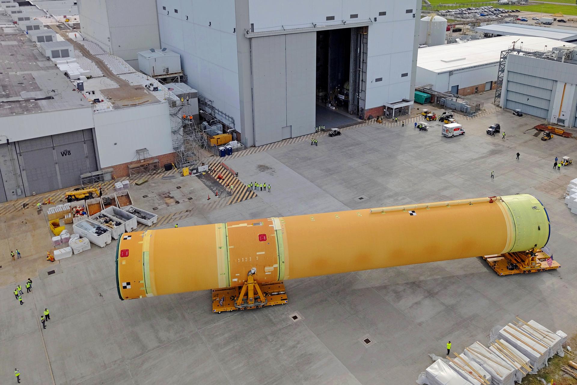 NASA moved the core stage, or the largest section, of the SLS (Space Launch System) rocket that will launch the crewed Artemis III mission in 2027 from the agency’s Michoud Assembly Facility to the agency’s Pegasus barge in New Orleans on April 20. The barge will ferry the top four-fifths – the section containing the liquid hydrogen tank, liquid oxygen tank, intertank, and forward skirt – of the SLS core stage to NASA’s Kennedy Space Center in Florida to complete outfitting and vertical integration.  Teams with NASA and Boeing, the SLS core stage lead contractor, used specialized transporters to guide the top four-fifths from the NASA rocket factory to Pegasus. Prior to the move, technicians added an engine section transportation simulator to the rocket stage for shipment to the Space Coast.  Next year’s Artemis III mission will launch astronauts to Earth’s orbit aboard the Orion spacecraft on top of SLS to test rendezvous and docking capabilities between Orion and commercial spacecraft needed to land Artemis IV astronauts on the Moon in 2028. NASA’s SLS is the only rocket capable of sending Orion, astronauts, and supplies to the Moon in a single launch.  Image credit: NASA/Michael DeMocker