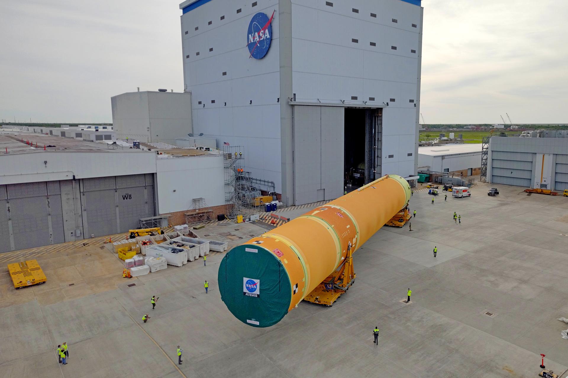 NASA moved the core stage, or the largest section, of the SLS (Space Launch System) rocket that will launch the crewed Artemis III mission in 2027 from the agency’s Michoud Assembly Facility to the agency’s Pegasus barge in New Orleans on April 20. The barge will ferry the top four-fifths – the section containing the liquid hydrogen tank, liquid oxygen tank, intertank, and forward skirt – of the SLS core stage to NASA’s Kennedy Space Center in Florida to complete outfitting and vertical integration.  Teams with NASA and Boeing, the SLS core stage lead contractor, used specialized transporters to guide the top four-fifths from the NASA rocket factory to Pegasus. Prior to the move, technicians added an engine section transportation simulator to the rocket stage for shipment to the Space Coast.  Next year’s Artemis III mission will launch astronauts to Earth’s orbit aboard the Orion spacecraft on top of SLS to test rendezvous and docking capabilities between Orion and commercial spacecraft needed to land Artemis IV astronauts on the Moon in 2028. NASA’s SLS is the only rocket capable of sending Orion, astronauts, and supplies to the Moon in a single launch.  Image credit: NASA/Michael DeMocker