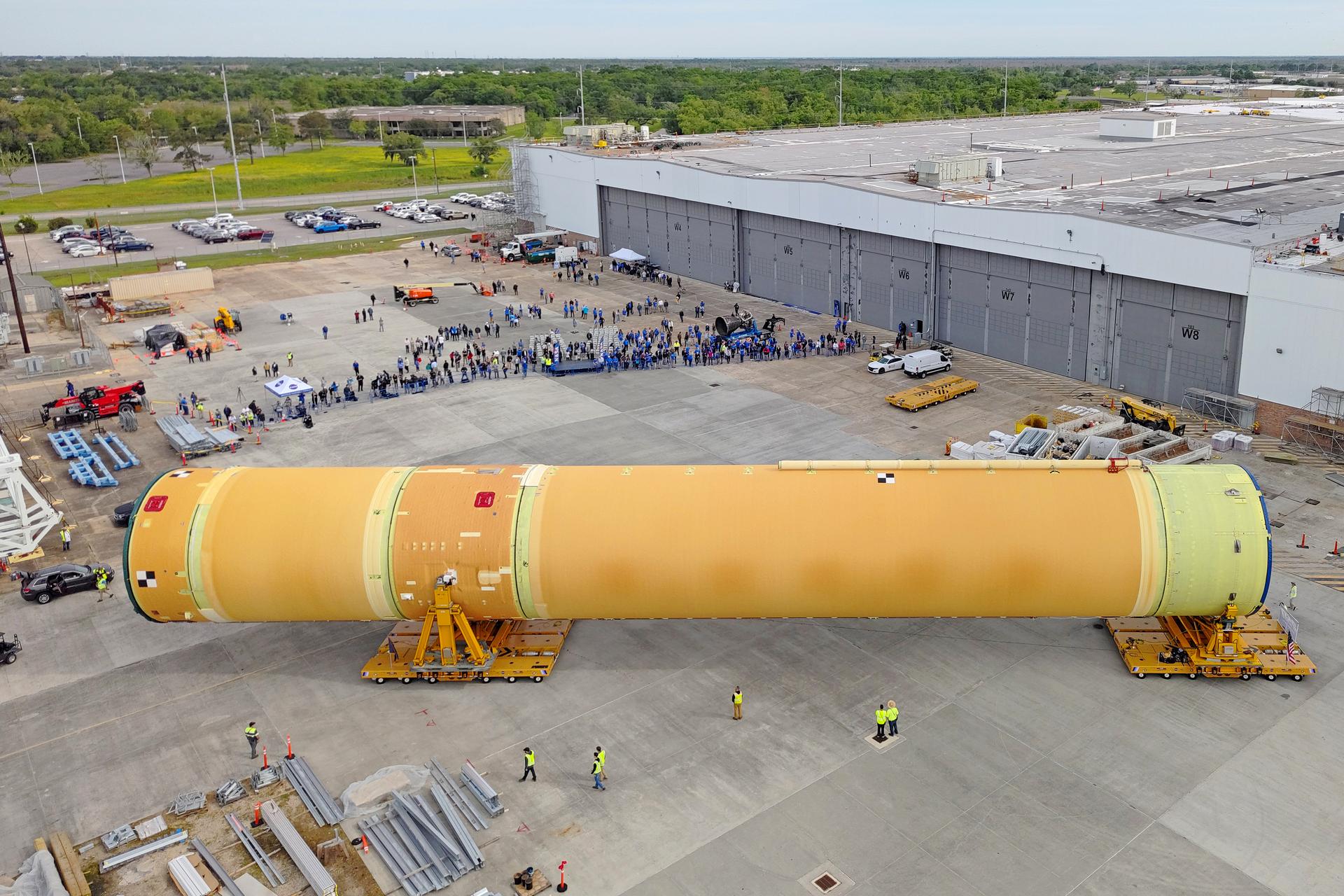NASA moved the core stage, or the largest section, of the SLS (Space Launch System) rocket that will launch the crewed Artemis III mission in 2027 from the agency’s Michoud Assembly Facility to the agency’s Pegasus barge in New Orleans on April 20. The barge will ferry the top four-fifths – the section containing the liquid hydrogen tank, liquid oxygen tank, intertank, and forward skirt – of the SLS core stage to NASA’s Kennedy Space Center in Florida to complete outfitting and vertical integration.  Teams with NASA and Boeing, the SLS core stage lead contractor, used specialized transporters to guide the top four-fifths from the NASA rocket factory to Pegasus. Prior to the move, technicians added an engine section transportation simulator to the rocket stage for shipment to the Space Coast.  Next year’s Artemis III mission will launch astronauts to Earth’s orbit aboard the Orion spacecraft on top of SLS to test rendezvous and docking capabilities between Orion and commercial spacecraft needed to land Artemis IV astronauts on the Moon in 2028. NASA’s SLS is the only rocket capable of sending Orion, astronauts, and supplies to the Moon in a single launch.  Image credit: NASA/Michael DeMocker