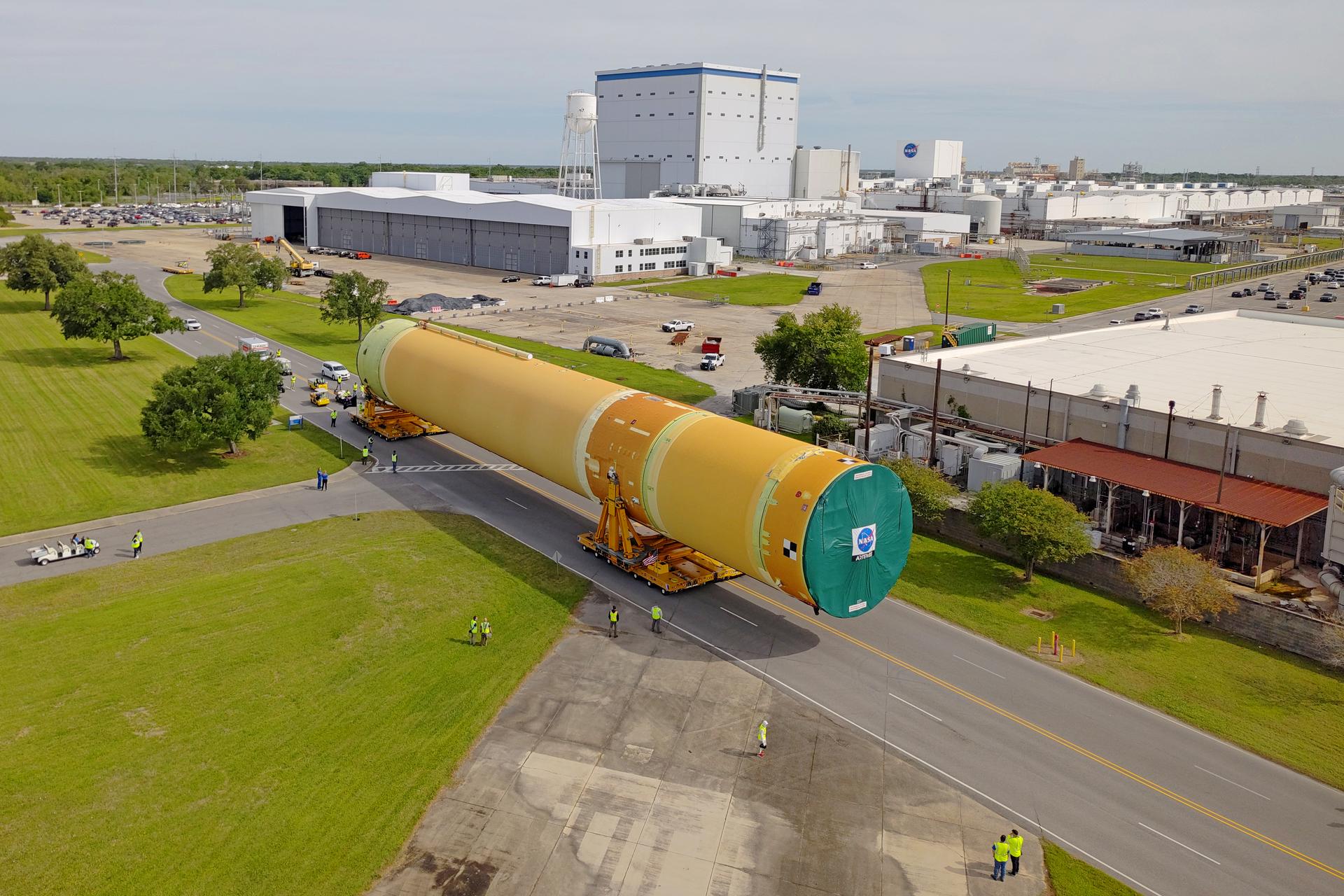 NASA moved the core stage, or the largest section, of the SLS (Space Launch System) rocket that will launch the crewed Artemis III mission in 2027 from the agency’s Michoud Assembly Facility to the agency’s Pegasus barge in New Orleans on April 20. The barge will ferry the top four-fifths – the section containing the liquid hydrogen tank, liquid oxygen tank, intertank, and forward skirt – of the SLS core stage to NASA’s Kennedy Space Center in Florida to complete outfitting and vertical integration.  Teams with NASA and Boeing, the SLS core stage lead contractor, used specialized transporters to guide the top four-fifths from the NASA rocket factory to Pegasus. Prior to the move, technicians added an engine section transportation simulator to the rocket stage for shipment to the Space Coast.  Next year’s Artemis III mission will launch astronauts to Earth’s orbit aboard the Orion spacecraft on top of SLS to test rendezvous and docking capabilities between Orion and commercial spacecraft needed to land Artemis IV astronauts on the Moon in 2028. NASA’s SLS is the only rocket capable of sending Orion, astronauts, and supplies to the Moon in a single launch.  Image credit: NASA/Michael DeMocker