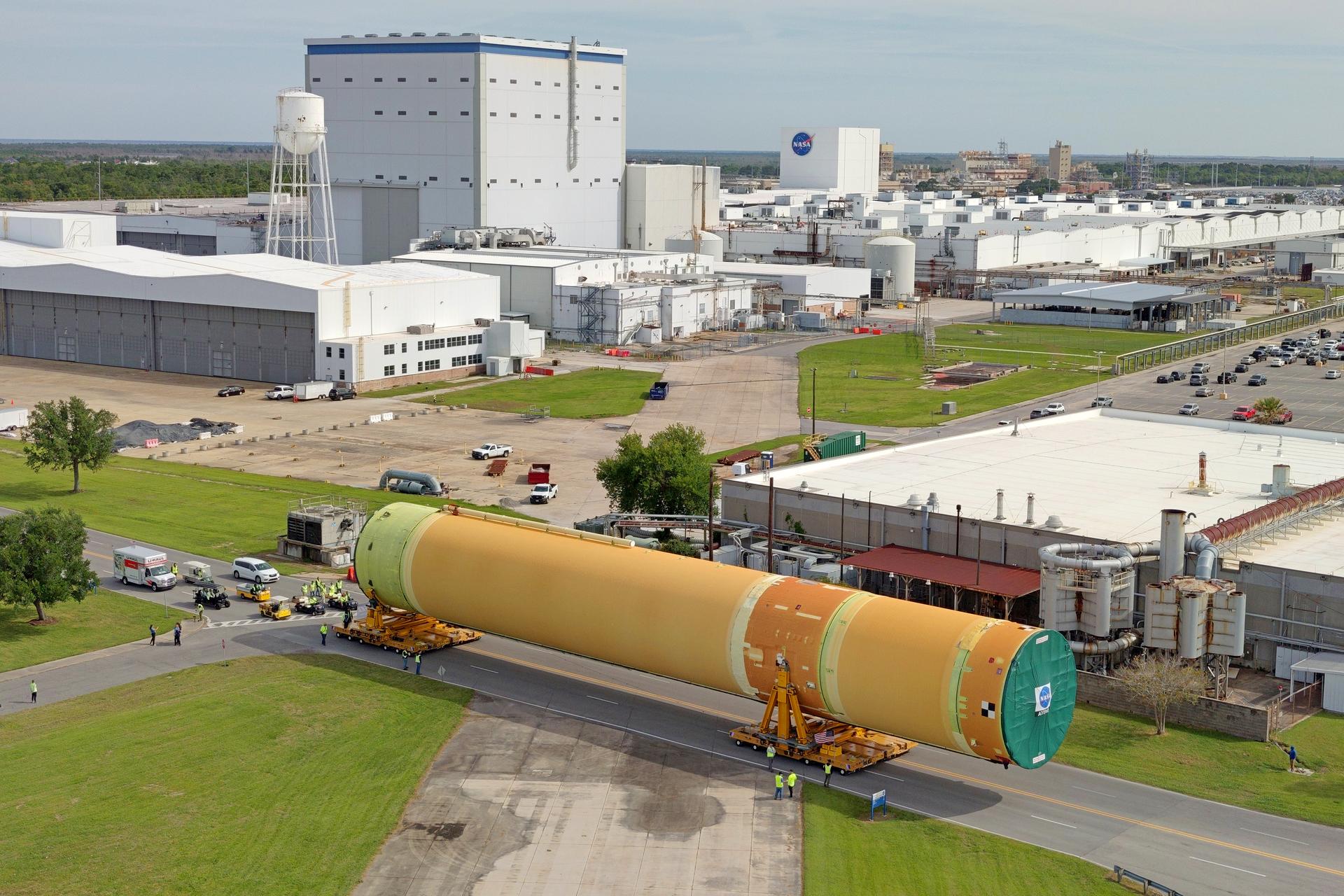 NASA moved the core stage, or the largest section, of the SLS (Space Launch System) rocket that will launch the crewed Artemis III mission in 2027 from the agency’s Michoud Assembly Facility to the agency’s Pegasus barge in New Orleans on April 20. The barge will ferry the top four-fifths – the section containing the liquid hydrogen tank, liquid oxygen tank, intertank, and forward skirt – of the SLS core stage to NASA’s Kennedy Space Center in Florida to complete outfitting and vertical integration.  Teams with NASA and Boeing, the SLS core stage lead contractor, used specialized transporters to guide the top four-fifths from the NASA rocket factory to Pegasus. Prior to the move, technicians added an engine section transportation simulator to the rocket stage for shipment to the Space Coast.  Next year’s Artemis III mission will launch astronauts to Earth’s orbit aboard the Orion spacecraft on top of SLS to test rendezvous and docking capabilities between Orion and commercial spacecraft needed to land Artemis IV astronauts on the Moon in 2028. NASA’s SLS is the only rocket capable of sending Orion, astronauts, and supplies to the Moon in a single launch.  