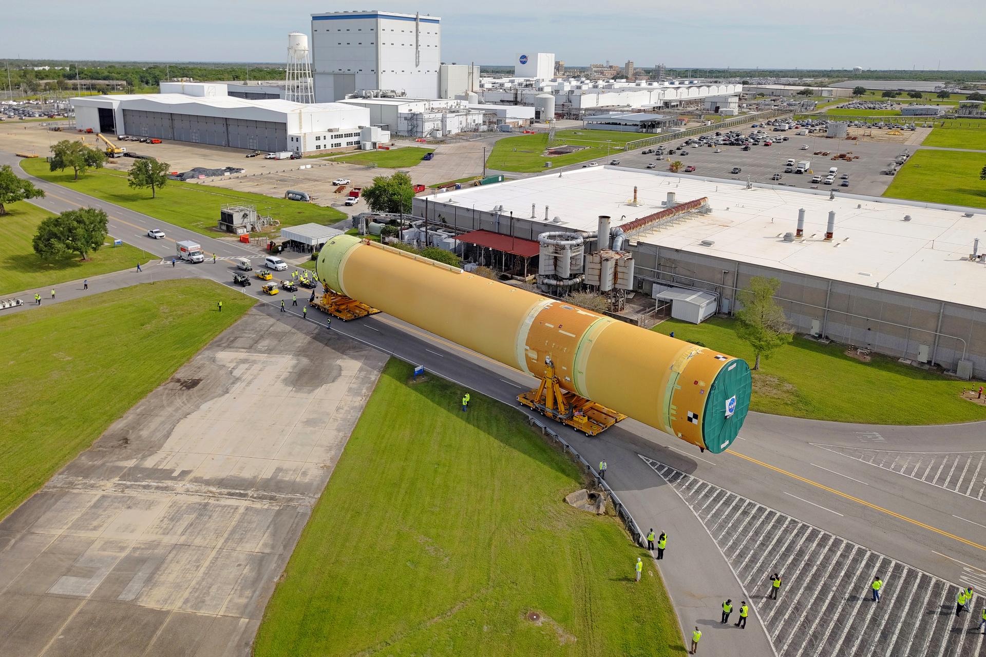 NASA moved the core stage, or the largest section, of the SLS (Space Launch System) rocket that will launch the crewed Artemis III mission in 2027 from the agency’s Michoud Assembly Facility to the agency’s Pegasus barge in New Orleans on April 20. The barge will ferry the top four-fifths – the section containing the liquid hydrogen tank, liquid oxygen tank, intertank, and forward skirt – of the SLS core stage to NASA’s Kennedy Space Center in Florida to complete outfitting and vertical integration.  Teams with NASA and Boeing, the SLS core stage lead contractor, used specialized transporters to guide the top four-fifths from the NASA rocket factory to Pegasus. Prior to the move, technicians added an engine section transportation simulator to the rocket stage for shipment to the Space Coast.  Next year’s Artemis III mission will launch astronauts to Earth’s orbit aboard the Orion spacecraft on top of SLS to test rendezvous and docking capabilities between Orion and commercial spacecraft needed to land Artemis IV astronauts on the Moon in 2028. NASA’s SLS is the only rocket capable of sending Orion, astronauts, and supplies to the Moon in a single launch.  Image credit: NASA/Michael DeMocker