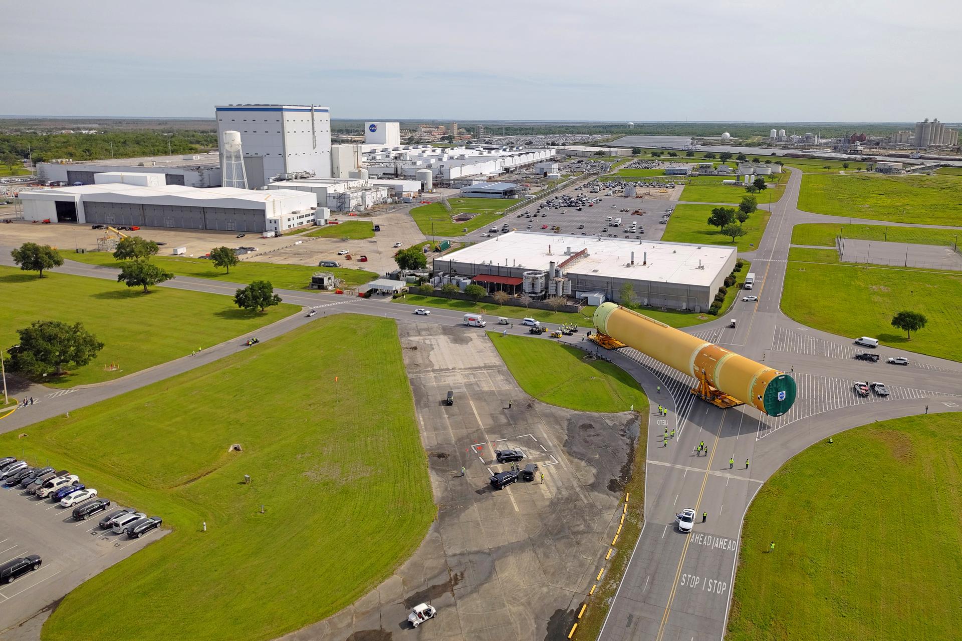 NASA moved the core stage, or the largest section, of the SLS (Space Launch System) rocket that will launch the crewed Artemis III mission in 2027 from the agency’s Michoud Assembly Facility to the agency’s Pegasus barge in New Orleans on April 20. The barge will ferry the top four-fifths – the section containing the liquid hydrogen tank, liquid oxygen tank, intertank, and forward skirt – of the SLS core stage to NASA’s Kennedy Space Center in Florida to complete outfitting and vertical integration.  Teams with NASA and Boeing, the SLS core stage lead contractor, used specialized transporters to guide the top four-fifths from the NASA rocket factory to Pegasus. Prior to the move, technicians added an engine section transportation simulator to the rocket stage for shipment to the Space Coast.  Next year’s Artemis III mission will launch astronauts to Earth’s orbit aboard the Orion spacecraft on top of SLS to test rendezvous and docking capabilities between Orion and commercial spacecraft needed to land Artemis IV astronauts on the Moon in 2028. NASA’s SLS is the only rocket capable of sending Orion, astronauts, and supplies to the Moon in a single launch.  Image credit: NASA/Michael DeMocker