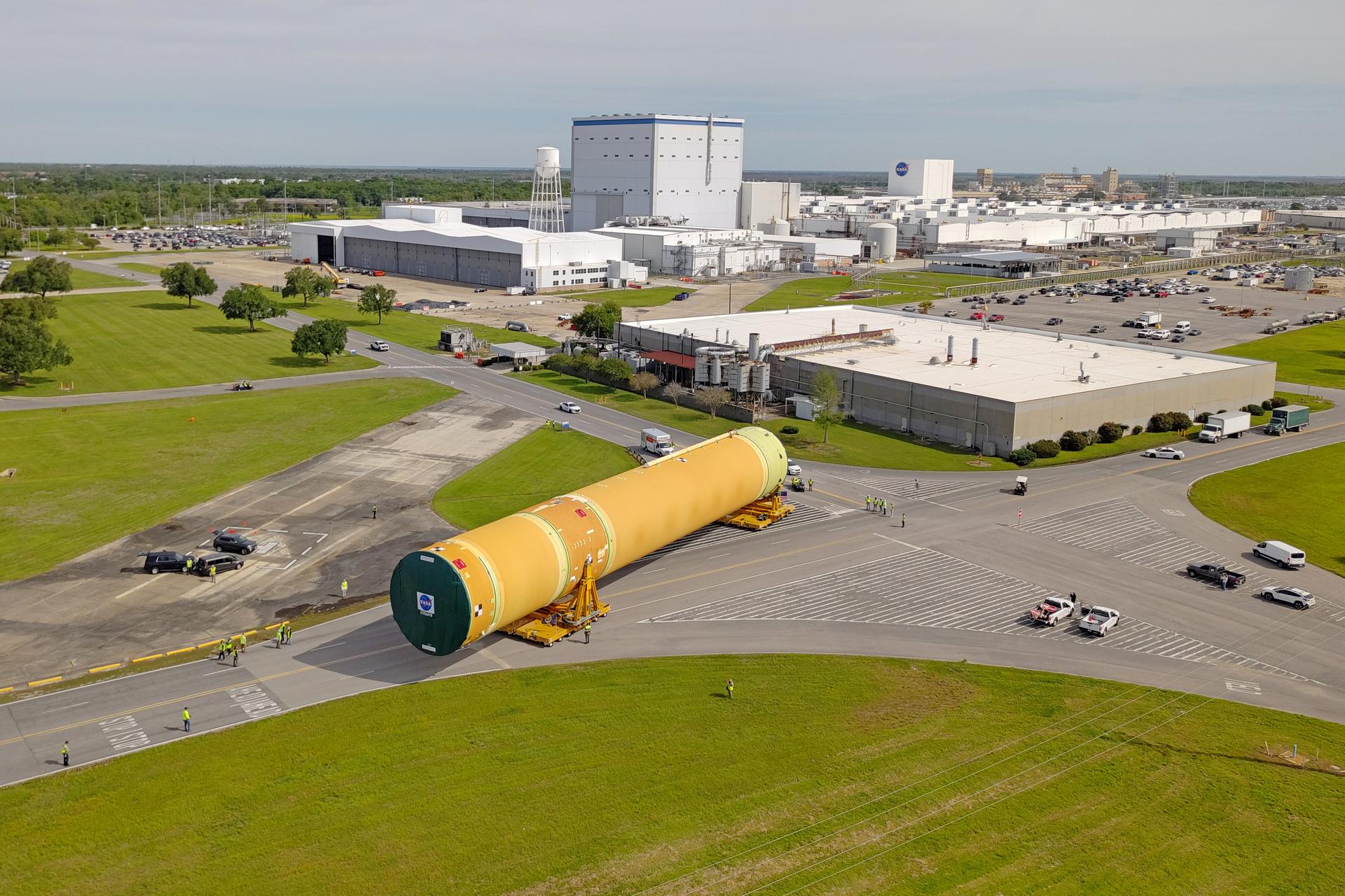 NASA moved the core stage, or the largest section, of the SLS (Space Launch System) rocket that will launch the crewed Artemis III mission in 2027 from the agency’s Michoud Assembly Facility to the agency’s Pegasus barge in New Orleans on April 20. The barge will ferry the top four-fifths – the section containing the liquid hydrogen tank, liquid oxygen tank, intertank, and forward skirt – of the SLS core stage to NASA’s Kennedy Space Center in Florida to complete outfitting and vertical integration.  Teams with NASA and Boeing, the SLS core stage lead contractor, used specialized transporters to guide the top four-fifths from the NASA rocket factory to Pegasus. Prior to the move, technicians added an engine section transportation simulator to the rocket stage for shipment to the Space Coast.  Next year’s Artemis III mission will launch astronauts to Earth’s orbit aboard the Orion spacecraft on top of SLS to test rendezvous and docking capabilities between Orion and commercial spacecraft needed to land Artemis IV astronauts on the Moon in 2028. NASA’s SLS is the only rocket capable of sending Orion, astronauts, and supplies to the Moon in a single launch. 