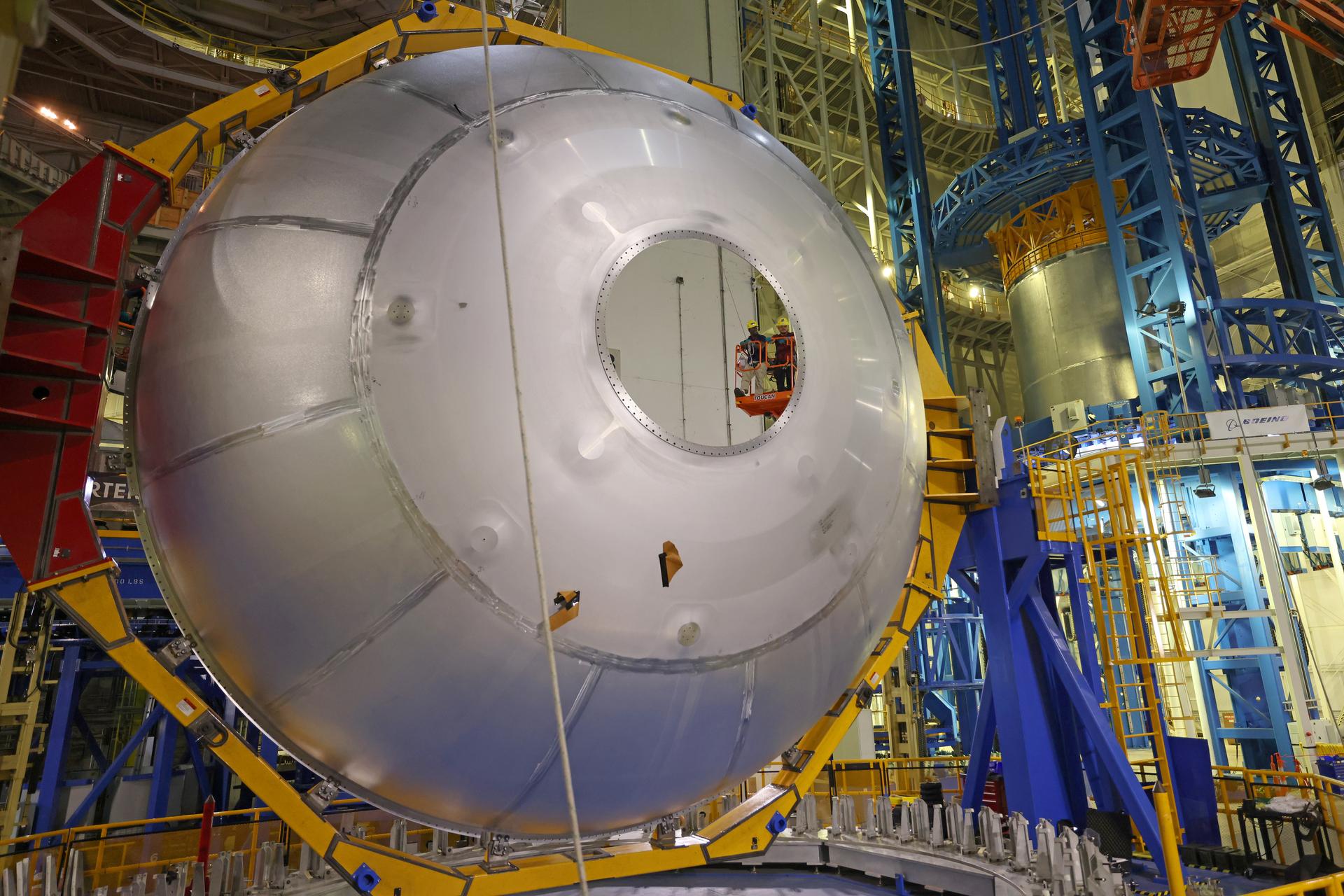 Teams at NASA’s Michoud Assembly Facility in New Orleans lift the aft dome for the liquid oxygen tank into the Vertical Assembly Center on May 11. The flight hardware will form part of the SLS (Space Launch System) rocket’s core stage for the Artemis IV mission. The aft dome is the final piece to complete the liquid oxygen tank structure. Inside the vertical assembly center – one of the largest friction-stir weld tools in the world – NASA and Boeing, SLS core stage prime contractor, will perform a circumferential weld to join the dome to the previously welded forward dome and two barrel structures to form the full liquid oxygen tank structure. The propellant tank is one of five major elements that make up the 212-foot-tall rocket stage. The core stage, along with its four RS-25 engines at its base, produces more than two million pounds of thrust to help launch NASA’s Orion spacecraft, astronauts, and supplies beyond Earth’s orbit and to the lunar surface for Artemis. Image credit: NASA/Michael DeMocker