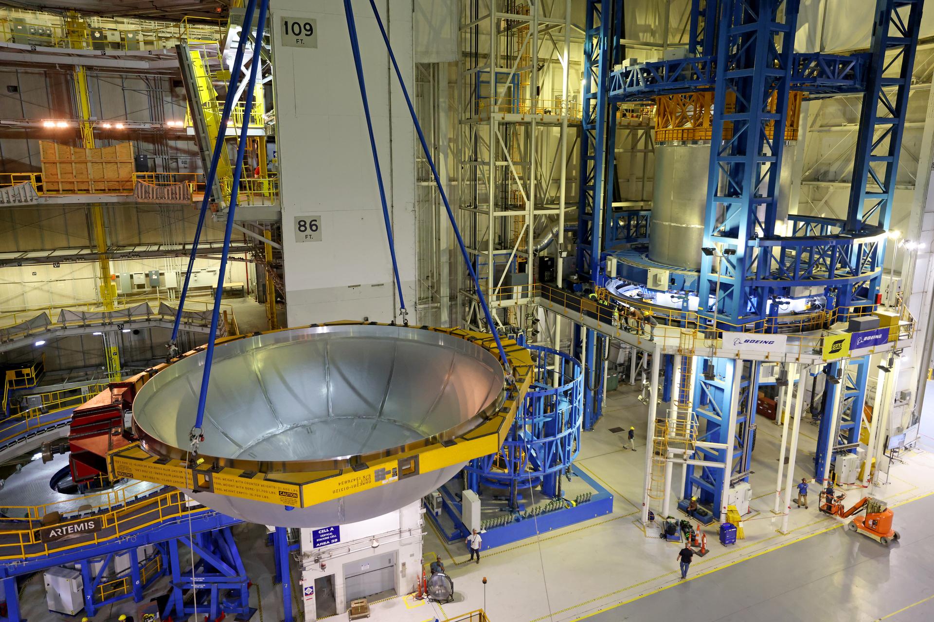 Teams at NASA’s Michoud Assembly Facility in New Orleans lift the aft dome for the liquid oxygen tank into the Vertical Assembly Center on May 11. The flight hardware will form part of the SLS (Space Launch System) rocket’s core stage for the Artemis IV mission. The aft dome is the final piece to complete the liquid oxygen tank structure. Inside the vertical assembly center – one of the largest friction-stir weld tools in the world – NASA and Boeing, SLS core stage prime contractor, will perform a circumferential weld to join the dome to the previously welded forward dome and two barrel structures to form the full liquid oxygen tank structure. The propellant tank is one of five major elements that make up the 212-foot-tall rocket stage. The core stage, along with its four RS-25 engines at its base, produces more than two million pounds of thrust to help launch NASA’s Orion spacecraft, astronauts, and supplies beyond Earth’s orbit and to the lunar surface for Artemis. Image credit: NASA/Michael DeMocker