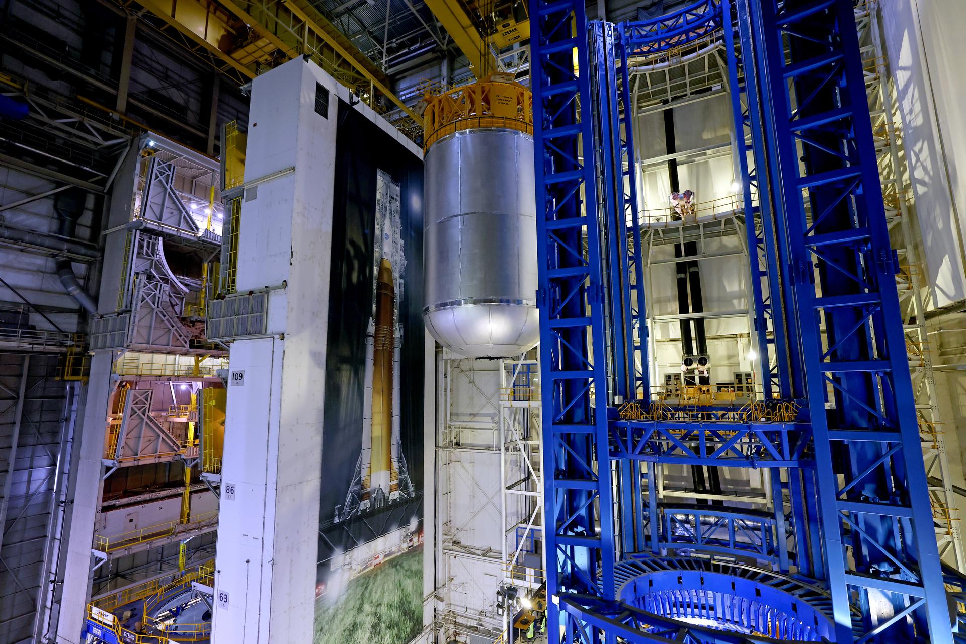 Teams at NASA’s Michoud Assembly Facility in New Orleans use an overhead crane to lift a 51-foot-tall liquid oxygen tank out of the vertical assembly center on May 26. The liquid oxygen tank will form part of the SLS (Space Launch System) rocket for NASA’s Artemis IV mission to the Moon. It will hold more than 196,000 gallons of super-cold liquid oxygen; and next, technicians with Boeing, SLS core stage prime contractor, and NASA will perform dimensional inspections and install internal baffles on the propellant tank before the next phase of production.    The propellant tank is one of five major elements that make up the 212-foot-tall SLS rocket stage. The core stage, along with its four RS-25 engines at its base, produces more than two million pounds of thrust to help launch NASA’s Orion spacecraft, astronauts, and supplies beyond Earth’s orbit and to the lunar surface for Artemis.      Image credit: NASA/Michael DeMocker