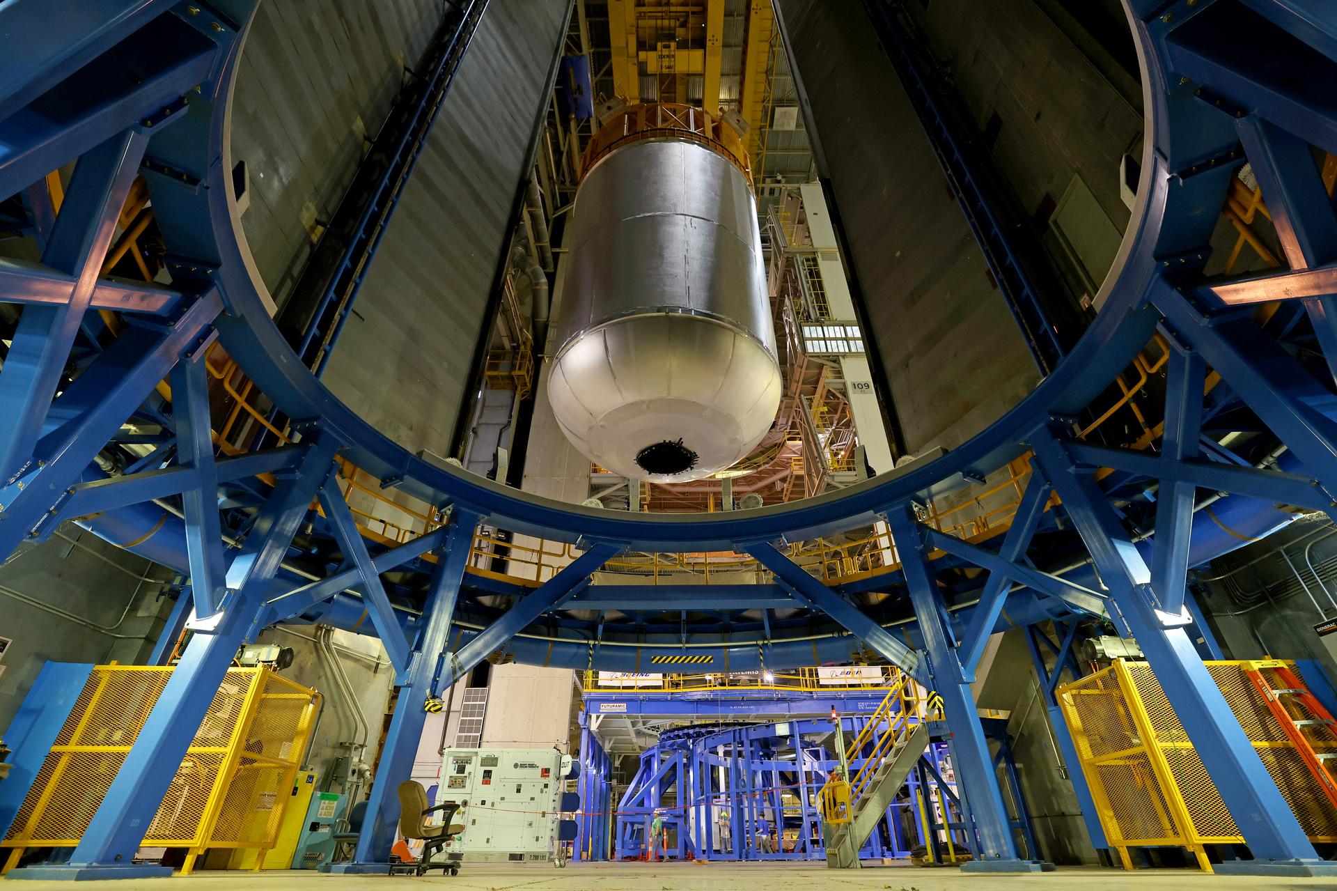 Teams at NASA’s Michoud Assembly Facility in New Orleans use an overhead crane to lift a 51-foot-tall liquid oxygen tank out of the vertical assembly center on May 26. The liquid oxygen tank will form part of the SLS (Space Launch System) rocket for NASA’s Artemis IV mission to the Moon. It will hold more than 196,000 gallons of super-cold liquid oxygen; and next, technicians with Boeing, SLS core stage prime contractor, and NASA will perform dimensional inspections and install internal baffles on the propellant tank before the next phase of production.    The propellant tank is one of five major elements that make up the 212-foot-tall SLS rocket stage. The core stage, along with its four RS-25 engines at its base, produces more than two million pounds of thrust to help launch NASA’s Orion spacecraft, astronauts, and supplies beyond Earth’s orbit and to the lunar surface for Artemis.      Image credit: NASA/Michael DeMocker