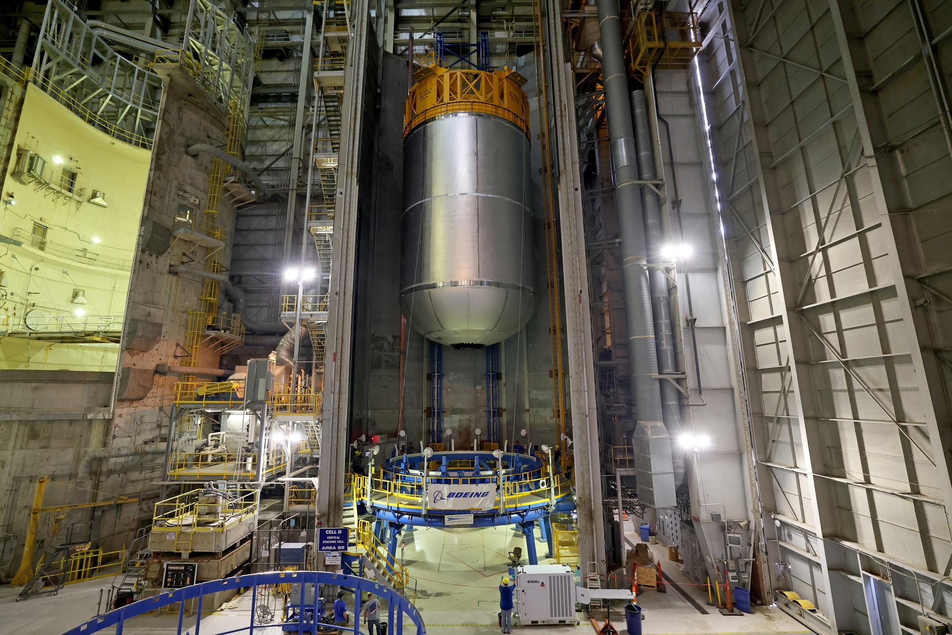 Teams at NASA’s Michoud Assembly Facility in New Orleans use an overhead crane to lift a 51-foot-tall liquid oxygen tank out of the vertical assembly center on May 26. The liquid oxygen tank will form part of the SLS (Space Launch System) rocket for NASA’s Artemis IV mission to the Moon. It will hold more than 196,000 gallons of super-cold liquid oxygen; and next, technicians with Boeing, SLS core stage prime contractor, and NASA will perform dimensional inspections and install internal baffles on the propellant tank before the next phase of production.    The propellant tank is one of five major elements that make up the 212-foot-tall SLS rocket stage. The core stage, along with its four RS-25 engines at its base, produces more than two million pounds of thrust to help launch NASA’s Orion spacecraft, astronauts, and supplies beyond Earth’s orbit and to the lunar surface for Artemis.      Image credit: NASA/Michael DeMocker