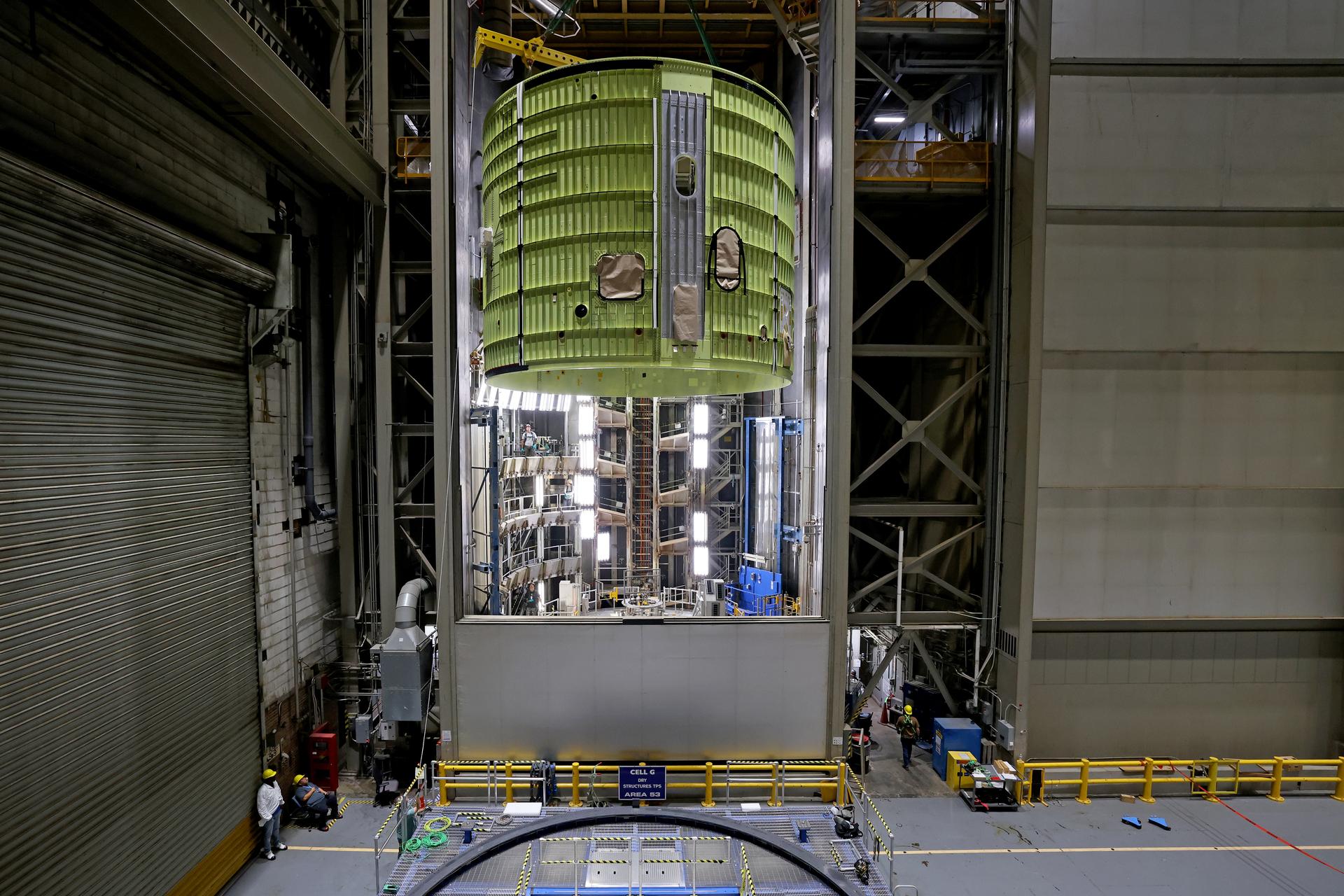 Teams at NASA’s Michoud Assembly Facility in New Orleans move the 21.8-foot-tall intertank for the core stage of the agency’s SLS (Space Launch System) rocket into one of the factory’s high bay production cells May 29. The flight hardware will help power NASA’s Artemis IV mission. Inside the production cell, NASA and Boeing, SLS core stage prime contractor will apply the hardware’s outer thermal protection layer through an automated process. The thermal protection system safeguards the rocket from the extreme temperatures and prevents the super-cooled propellant within the rocket’s massive propellant tanks from boiling off too rapidly during launch and flight.    The intertank houses avionics and electronics, serves as an attachment point for the solid rocket boosters, and is one of five major elements that make up the 212-foot-tall rocket stage. The core stage, along with its four RS-25 engines at its base, produce more than two million pounds of thrust to help launch NASA’s Orion spacecraft, astronauts, and supplies beyond Earth’s orbit and to the lunar surface for Artemis.      Image credit: NASA/Michael DeMocker