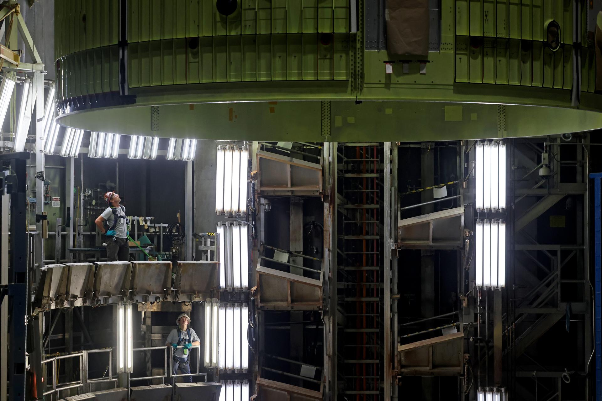 Teams at NASA’s Michoud Assembly Facility in New Orleans move the 21.8-foot-tall intertank for the core stage of the agency’s SLS (Space Launch System) rocket into one of the factory’s high bay production cells May 29. The flight hardware will help power NASA’s Artemis IV mission. Inside the production cell, NASA and Boeing, SLS core stage prime contractor will apply the hardware’s outer thermal protection layer through an automated process. The thermal protection system safeguards the rocket from the extreme temperatures and prevents the super-cooled propellant within the rocket’s massive propellant tanks from boiling off too rapidly during launch and flight.    The intertank houses avionics and electronics, serves as an attachment point for the solid rocket boosters, and is one of five major elements that make up the 212-foot-tall rocket stage. The core stage, along with its four RS-25 engines at its base, produce more than two million pounds of thrust to help launch NASA’s Orion spacecraft, astronauts, and supplies beyond Earth’s orbit and to the lunar surface for Artemis.      Image credit: NASA/Michael DeMocker