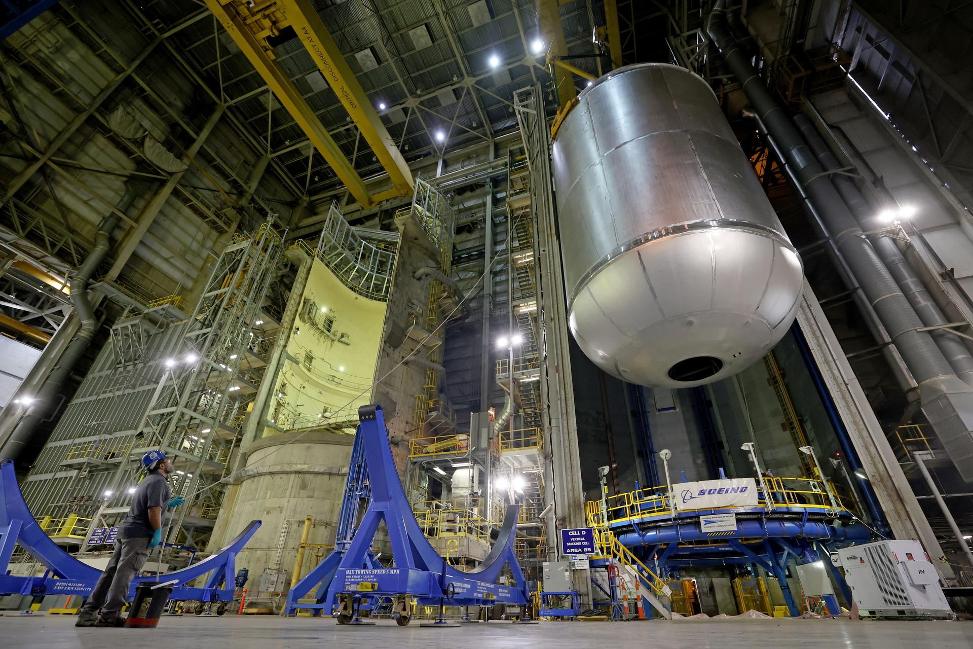 Teams at NASA’s Michoud Assembly Facility in New Orleans use an overhead crane to lift a 51-foot-tall liquid oxygen tank out of a production cell and into the main aisle of the vertical assembly building on June 9. The team rotates the tank from a vertical to a horizontal configuration in an operation called a “breakover,” and sets the tank into a pair of cradles until it is moved to its next phase of production. This liquid oxygen tank will form part of the SLS (Space Launch System) rocket for NASA’s Artemis IV mission to the Moon, and it will hold more than 196,000 gallons of super-cold liquid oxygen at launch. The propellant tank is one of five major elements that make up the 212-foot-tall SLS rocket stage. The core stage, along with its four RS-25 engines at its base, produces more than two million pounds of thrust to help launch NASA’s Orion spacecraft, astronauts, and supplies beyond Earth’s orbit and to the lunar surface for Artemis. Image credit: NASA/Michael DeMocker