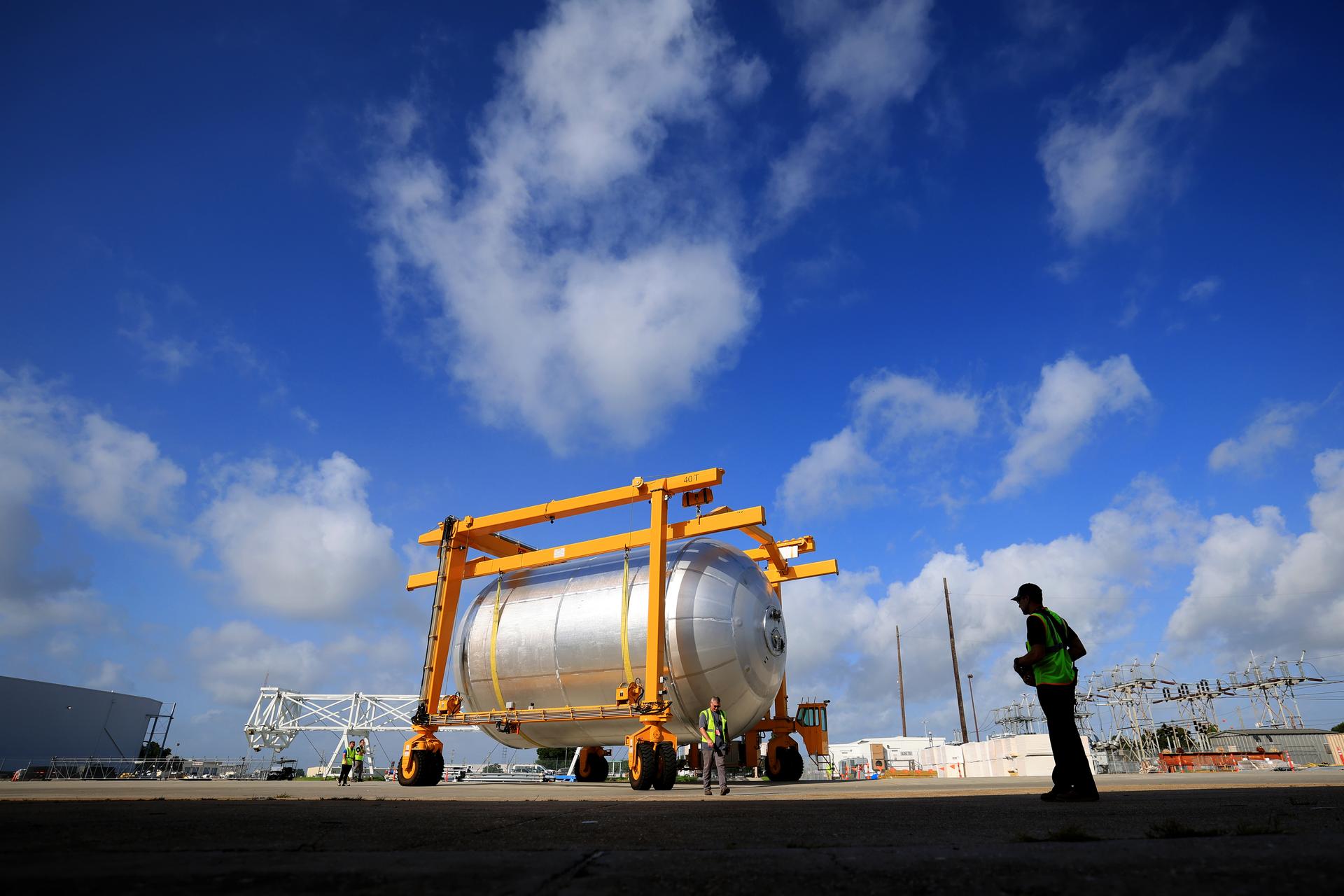 Teams at NASA’s Michoud Assembly Facility in New Orleans transport a 51-foot-tall liquid oxygen tank out of the vertical assembly building on July 23, 2026. The liquid oxygen tank, which will form part of the SLS (Space Launch System) rocket for NASA’s Artemis IV mission to the Moon, is suspended in a strap carrier transport apparatus and brought into the main factory building. Here, teams with SLS core stage prime contractor, Boeing, will perform post-proof non-destructive evaluations on the flight hardware before moving forward with tank cleaning. The propellant tank will hold more than 196,000 gallons of super-cooled liquid oxygen at launch and is one of five major elements that make up the 212-foot-tall SLS rocket stage. The core stage, along with its four RS-25 engines at its base, produces more than two million pounds of thrust to help launch NASA’s Orion spacecraft, astronauts, and supplies beyond Earth’s orbit and to the lunar surface for Artemis.  Image credit: NASA/Michael DeMocker
