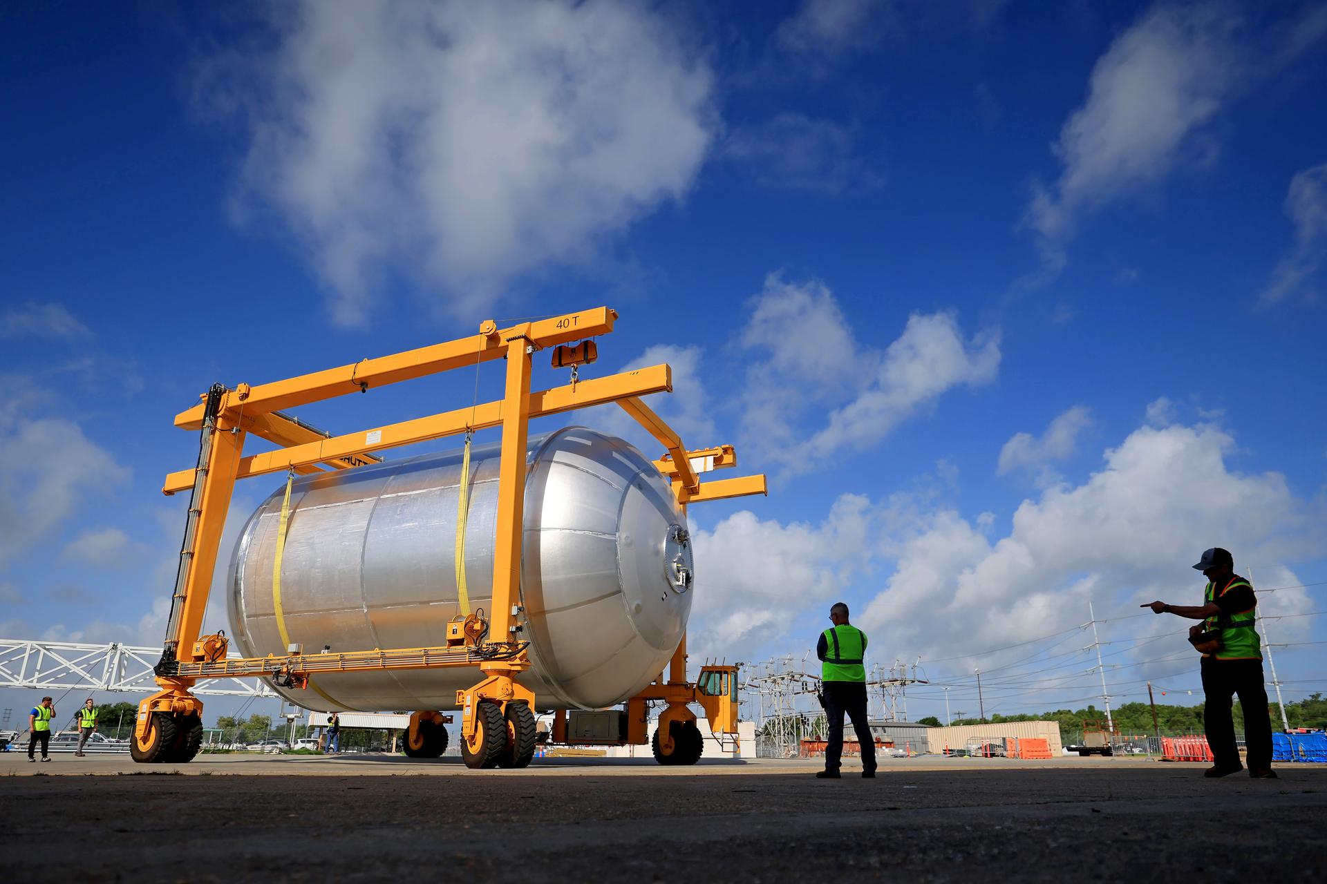 Teams at NASA’s Michoud Assembly Facility in New Orleans transport a 51-foot-tall liquid oxygen tank out of the vertical assembly building on July 23, 2026. The liquid oxygen tank, which will form part of the SLS (Space Launch System) rocket for NASA’s Artemis IV mission to the Moon, is suspended in a strap carrier transport apparatus and brought into the main factory building. Here, teams with SLS core stage prime contractor, Boeing, will perform post-proof non-destructive evaluations on the flight hardware before moving forward with tank cleaning. The propellant tank will hold more than 196,000 gallons of super-cooled liquid oxygen at launch and is one of five major elements that make up the 212-foot-tall SLS rocket stage. The core stage, along with its four RS-25 engines at its base, produces more than two million pounds of thrust to help launch NASA’s Orion spacecraft, astronauts, and supplies beyond Earth’s orbit and to the lunar surface for Artemis.  Image credit: NASA/Michael DeMocker