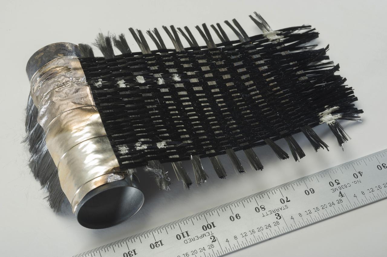 HAND-WOVEN MITSUBISHI K13D2U PITCH-BASED CARBON FIBERS BRAZED TO AN INCONEL TUBE.