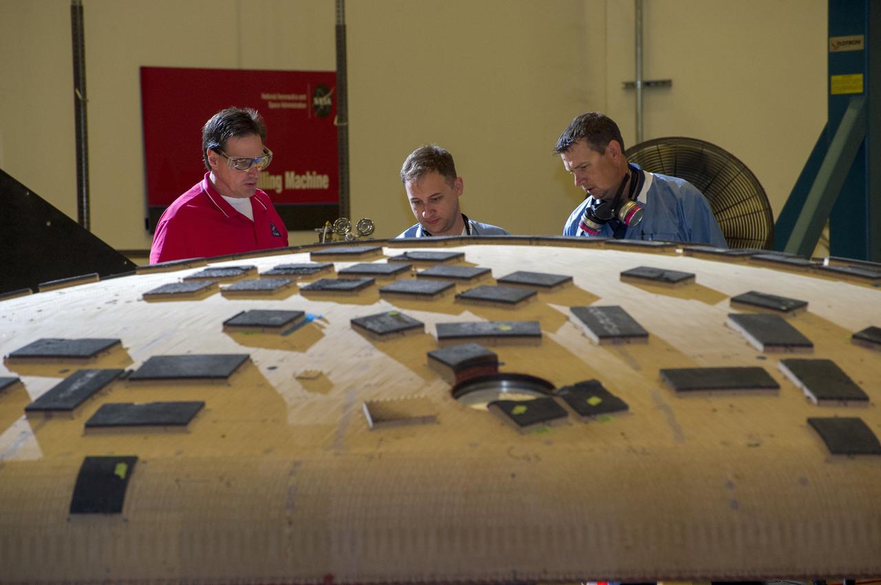 OVERSEEING ORION HEAT SHIELD WORK IN MARSHALL'S SEVEN-AXIS MILLING AND MACHINING FACILITY ARE, FROM LEFT, JOHN KOWAL, MANAGER OF ORION'S THERMAL PROTECTION SYSTEM AT JOHNSON SPACE CENTER; NICHOLAS CROWLEY, AN AMES ENGINEERING TECHNICIAN; AND ROB KORNIENKO, AMES ENGINEERING  BRANCH CHIEF. THE HEAT SHIELD FLEW TO SPACE DURING THE EFT-1 FULL SCALE FLIGHT TEST OF ORION IN DECEMBER, 2014