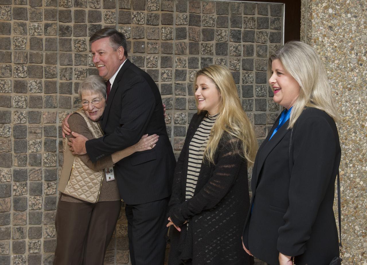 Patrick Scheuermann hugs Margo Thigpen at portrait unveiling event.
