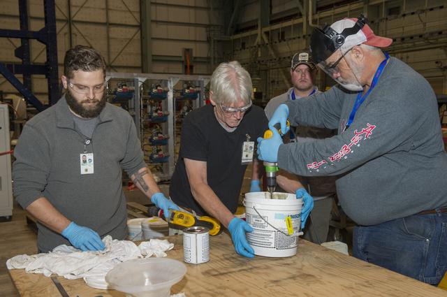 NASA image: TECHNICIANS MIX EPOXY