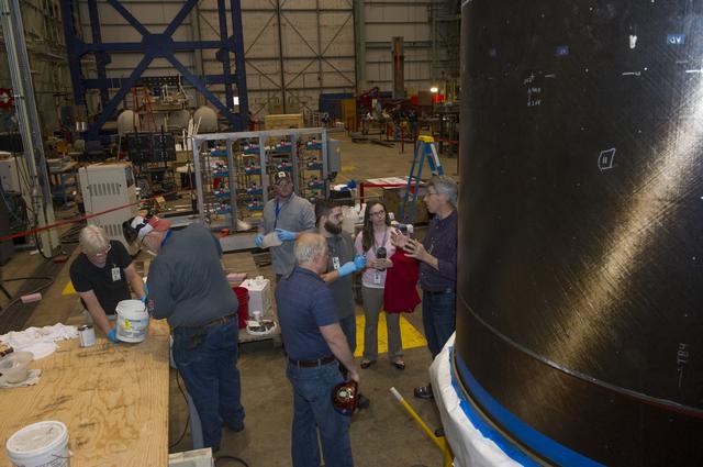 NASA image: TECHNICIANS MIX EPOXY